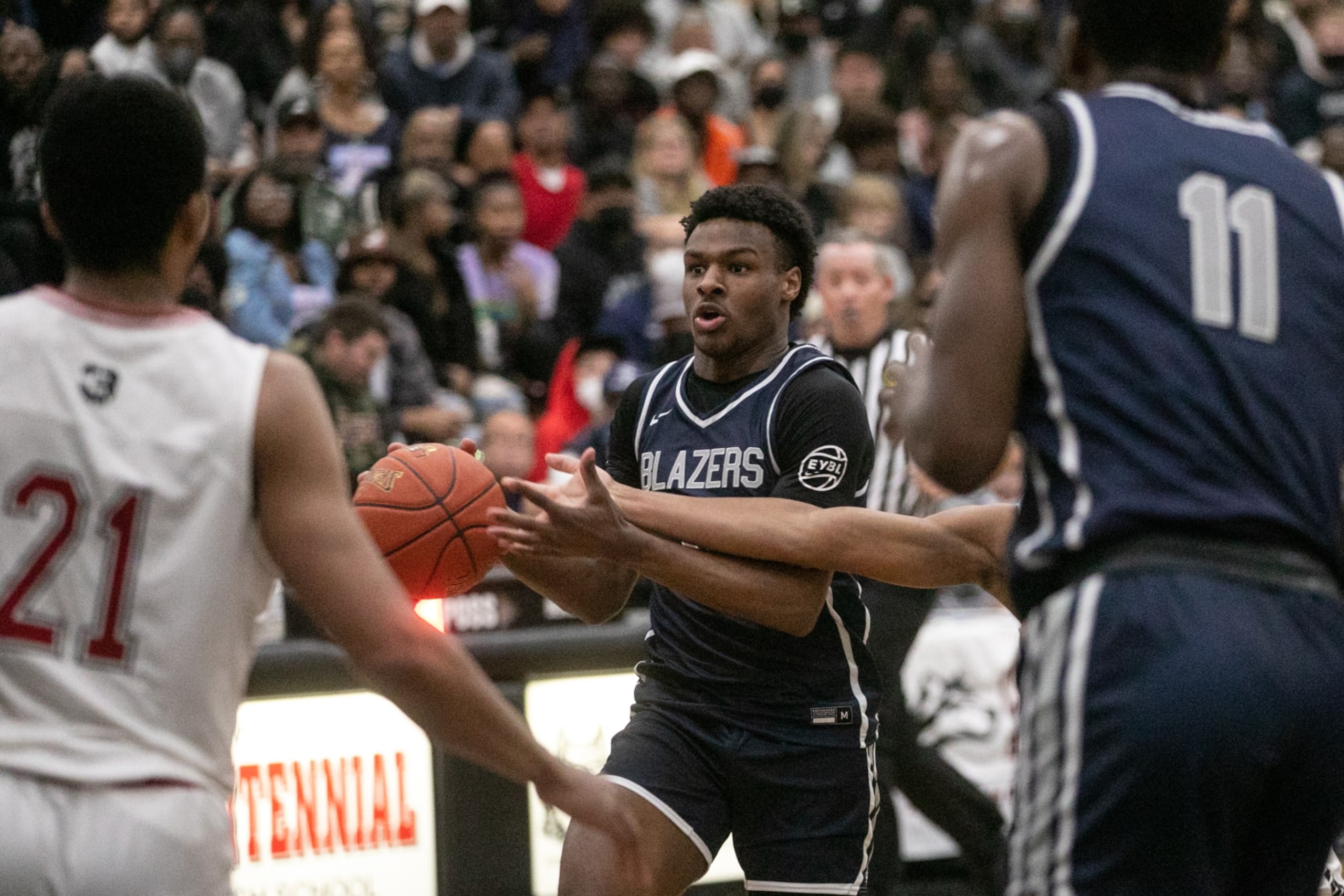 CORONA, CA - MARCH 08: Sierra Canyons Bronny James (0) drives the ball under pressure of Corona Centennial boys basketball team in the Southern California Open Division regional basketball finals on Tuesday, March 8, 2022 in Corona, CA.