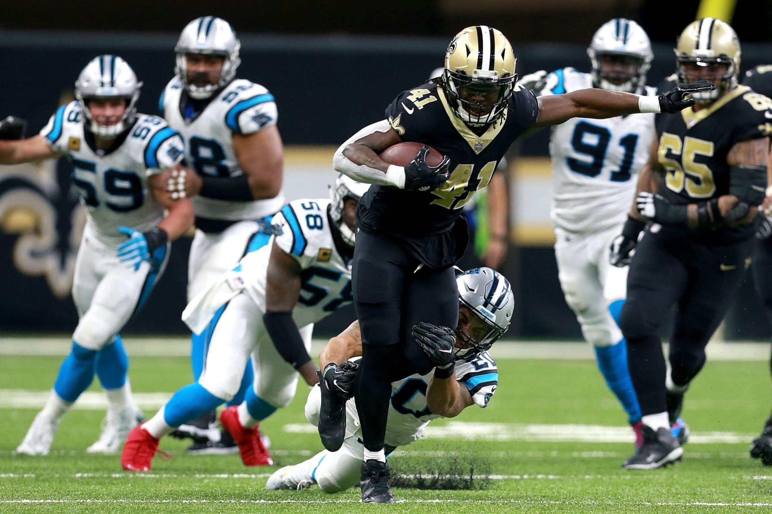 NEW ORLEANS, LA - DECEMBER 03:  Alvin Kamara #41 of the New Orleans Saints is tackled from behind by Kurt Coleman #20 of the Carolina Panthers during the second half of a NFL game at the Mercedes-Benz Superdome on December 3, 2017 in New Orleans, Louisiana. The New Orleans Saints won the game 31 - 21.  (Photo by Sean Gardner/Getty Images)