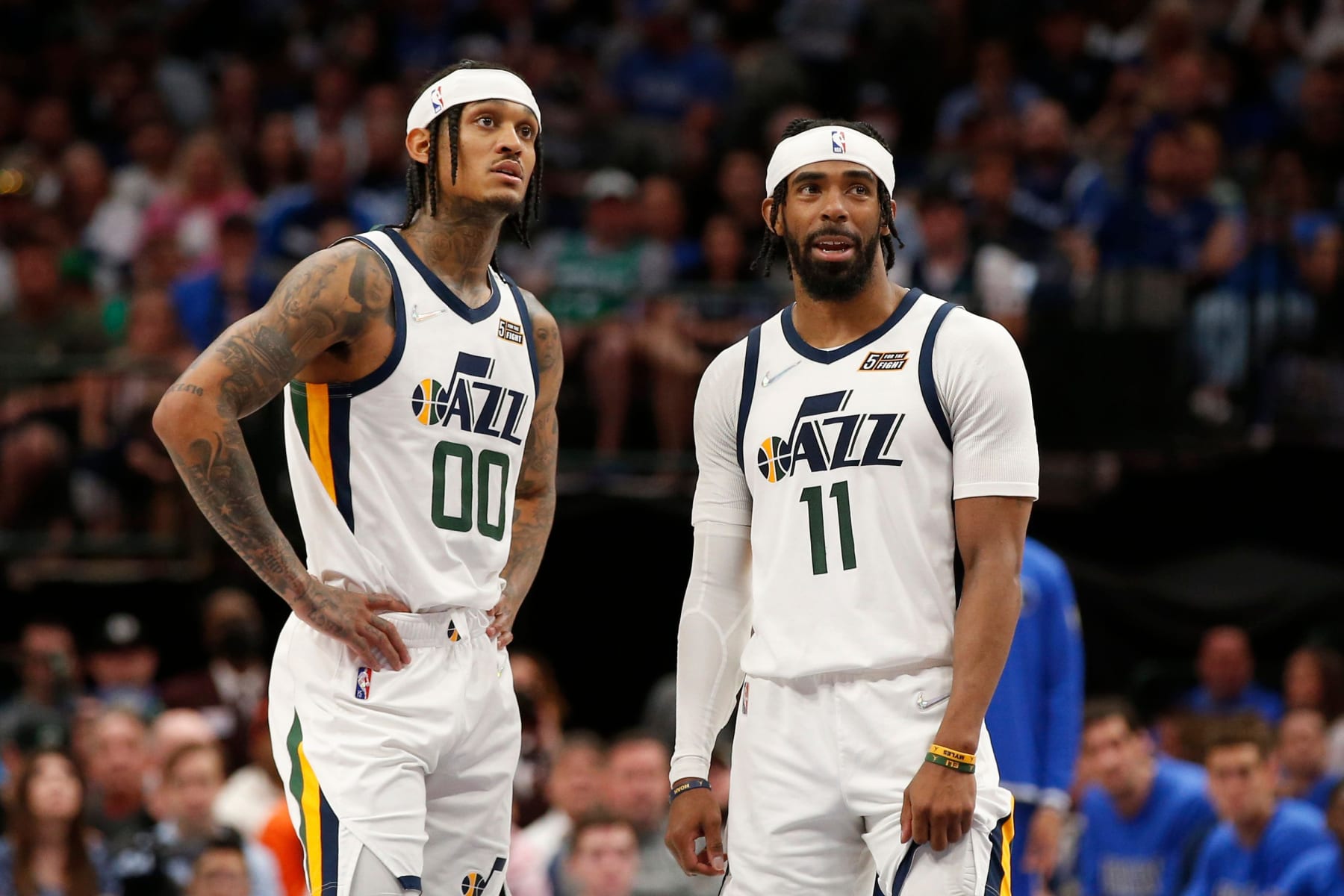 DALLAS, TEXAS - MARCH 27: Jordan Clarkson #00 and Mike Conley #11 of the Utah Jazz talk during a time out in the second half against the Dallas Mavericks at American Airlines Center on March 27, 2022 in Dallas, Texas. NOTE TO USER: User expressly acknowledges and agrees that, by downloading and or using this photograph, User is consenting to the terms and conditions of the Getty Images License Agreement.  (Photo by Tim Heitman/Getty Images)