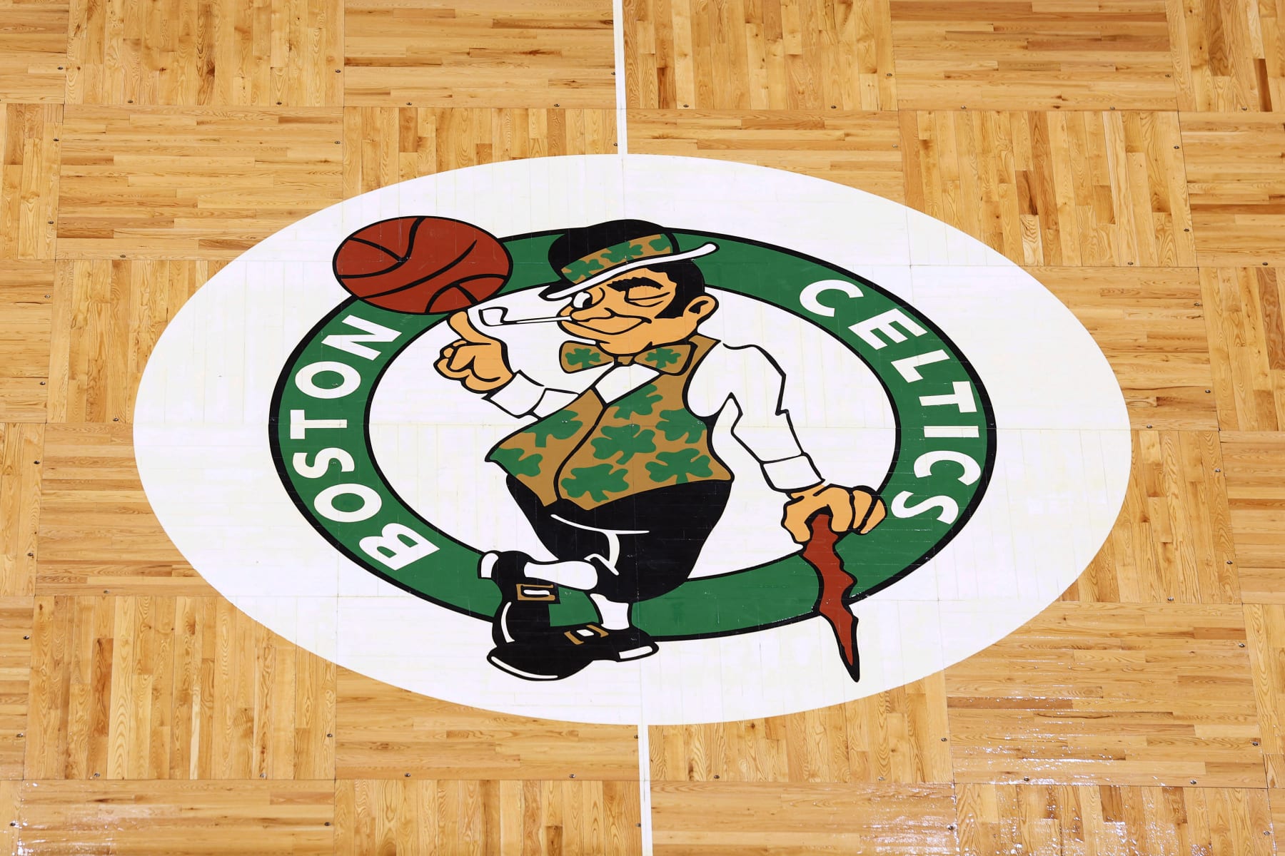 The Boston Celtics logo is seen at center court on the parquet floor before an NBA basketball game between the Boston Celtics and the Atlanta Hawks Sunday, Feb. 13, 2022, in Boston. (AP Photo/Winslow Townson)