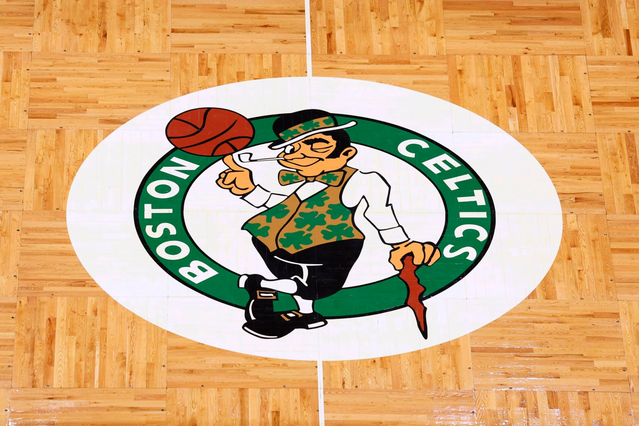 The Boston Celtics logo is seen at center court on the parquet floor before an NBA basketball game between the Boston Celtics and the Atlanta Hawks Sunday, Feb. 13, 2022, in Boston. (AP Photo/Winslow Townson)