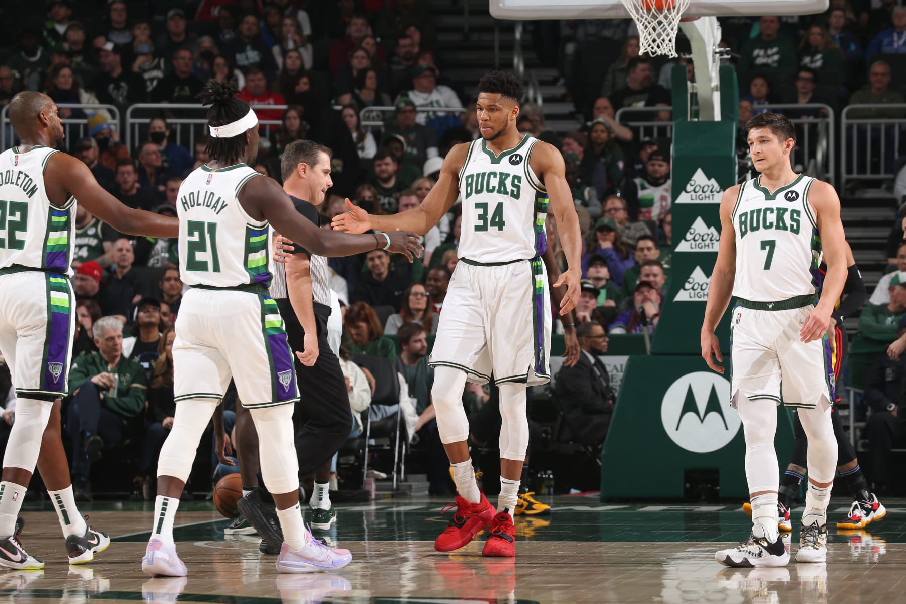 MILWAUKEE, WI - MARCH 9: Giannis Antetokounmpo #34 of the Milwaukee Bucks high fives Jrue Holiday #21 of the Milwaukee Bucks and Khris Middleton #22 of the Milwaukee Bucks during the game against the Atlanta Hawks on March 9, 2022 at the Fiserv Forum Center in Milwaukee, Wisconsin. NOTE TO USER: User expressly acknowledges and agrees that, by downloading and or using this Photograph, user is consenting to the terms and conditions of the Getty Images License Agreement. Mandatory Copyright Notice: Copyright 2022 NBAE (Photo by Gary Dineen/NBAE via Getty Images).