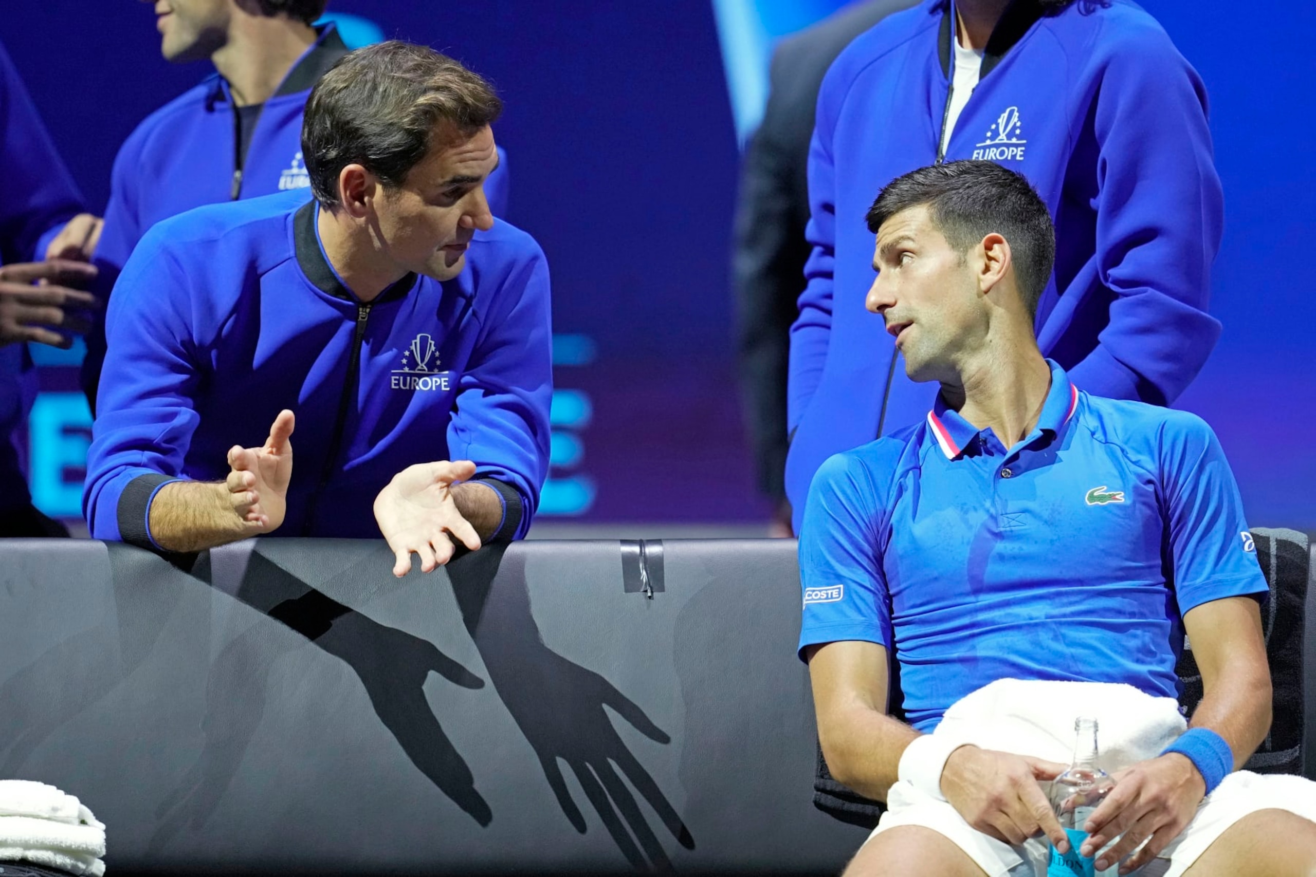 Team Europe's Novak Djokovic, right, listens to Roger Federer during a match against Team World's Frances Tiafoe on second day of the Laver Cup tennis tournament at the O2 in London, Saturday, Sept. 24, 2022. (AP Photo/Kin Cheung)