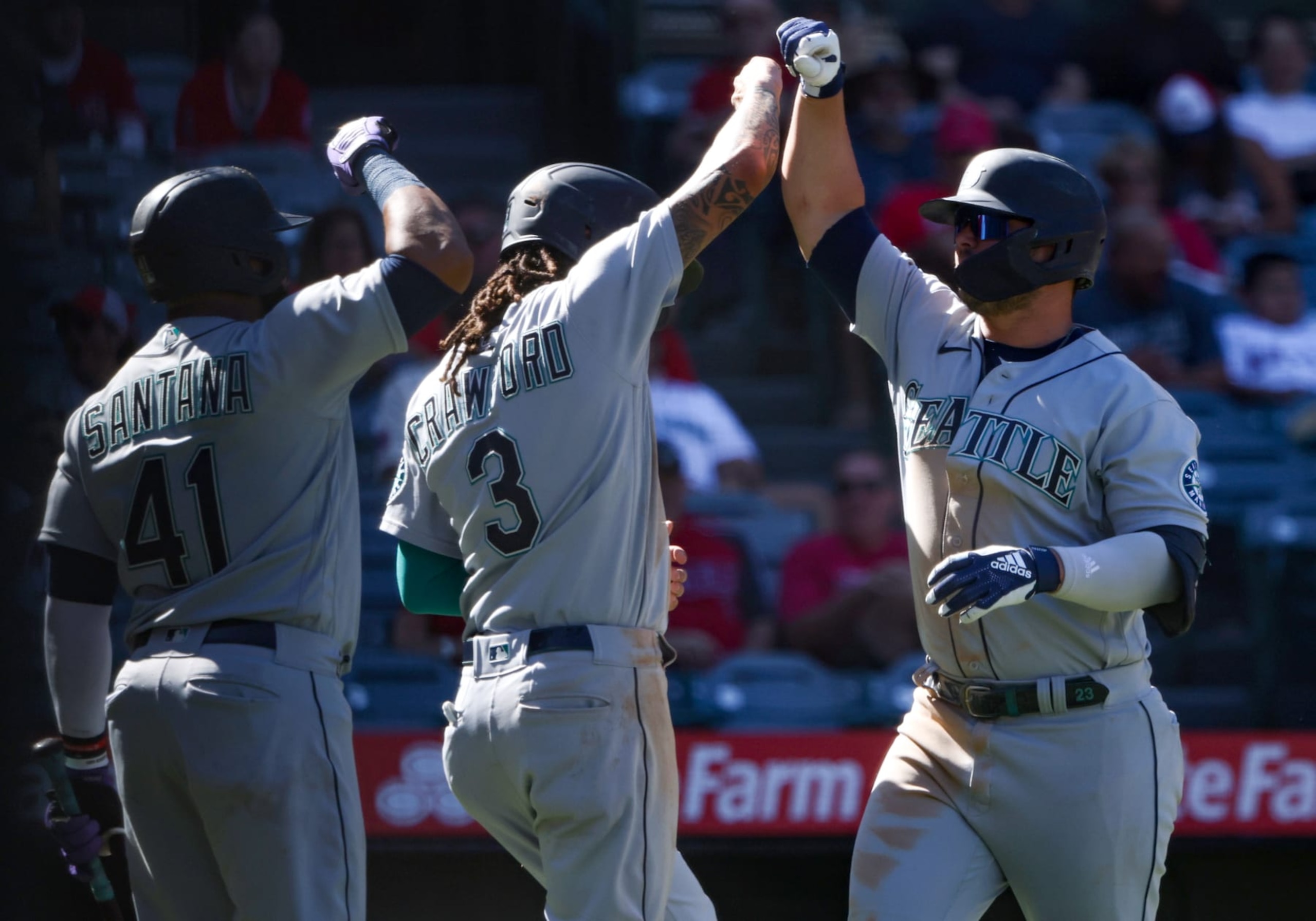 ANAHEIM, CALIFORNIA - SEPTEMBER 19: Ty France #23 of the Seattle Mariners celebrates his three run home run with teammates Carlos Santana #41 and J.P. Crawford #3 during the seventh inning against the Los Angeles Angels at Angel Stadium of Anaheim on September 19, 2022 in Anaheim, California. (Photo by Katelyn Mulcahy/Getty Images)