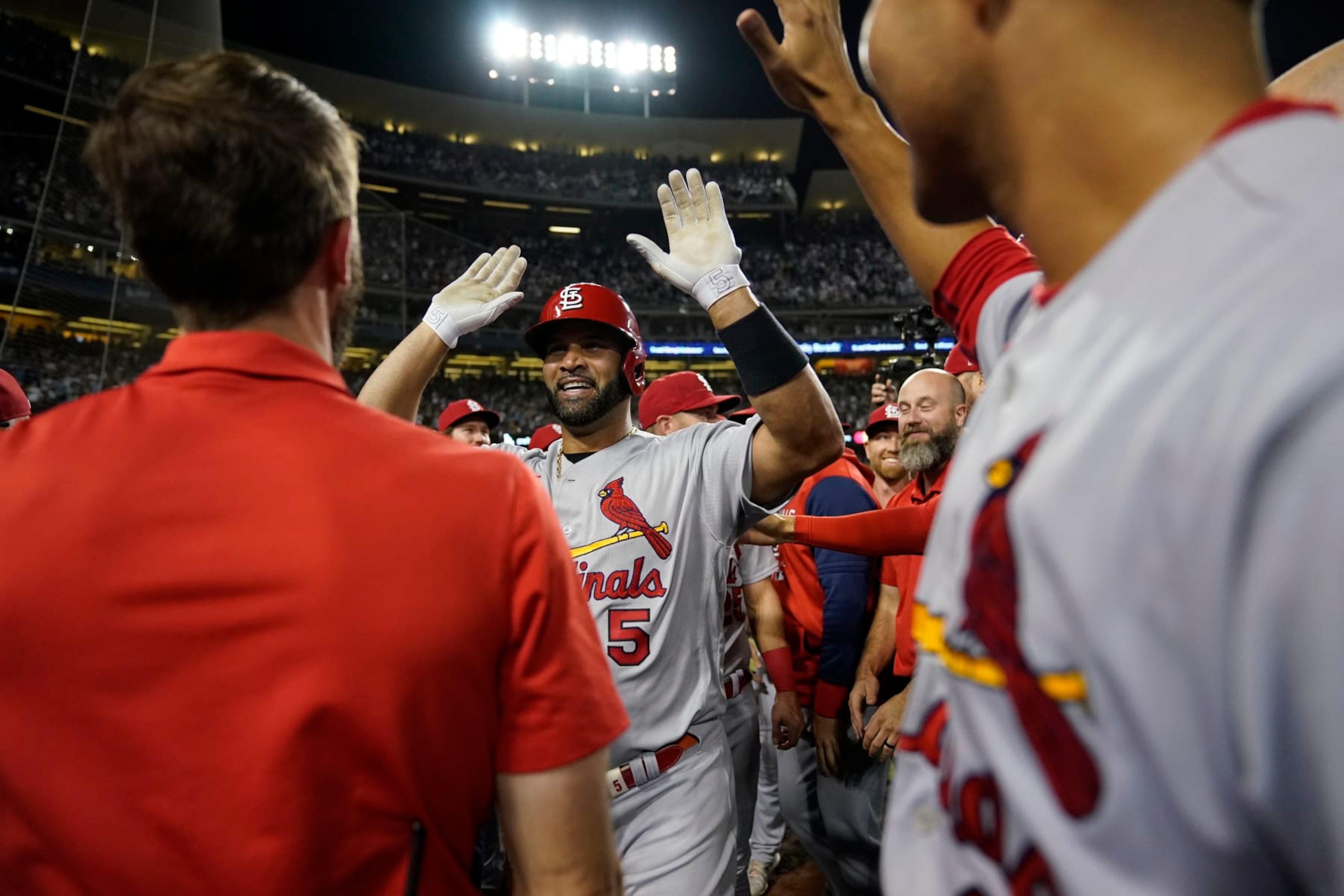 St. Louis Cardinals designated hitter Albert Pujols, center, celebrates with teammates after hitting a home run during the fourth inning of a baseball game against the Los Angeles Dodgers in Los Angeles, Friday, Sept. 23, 2022. Brendan Donovan and Tommy Edman also scored. It was Pujols' 700th career home run. (AP Photo/Ashley Landis) St. Louis Cardinals designated hitter Albert Pujols, center, celebrates with teammates after hitting a home run during the fourth inning of a baseball game against the Los Angeles Dodgers in Los Angeles, Friday, Sept. 23, 2022. Brendan Donovan and Tommy Edman also scored. It was Pujols' 700th career home run. (AP Photo/Ashley Landis)