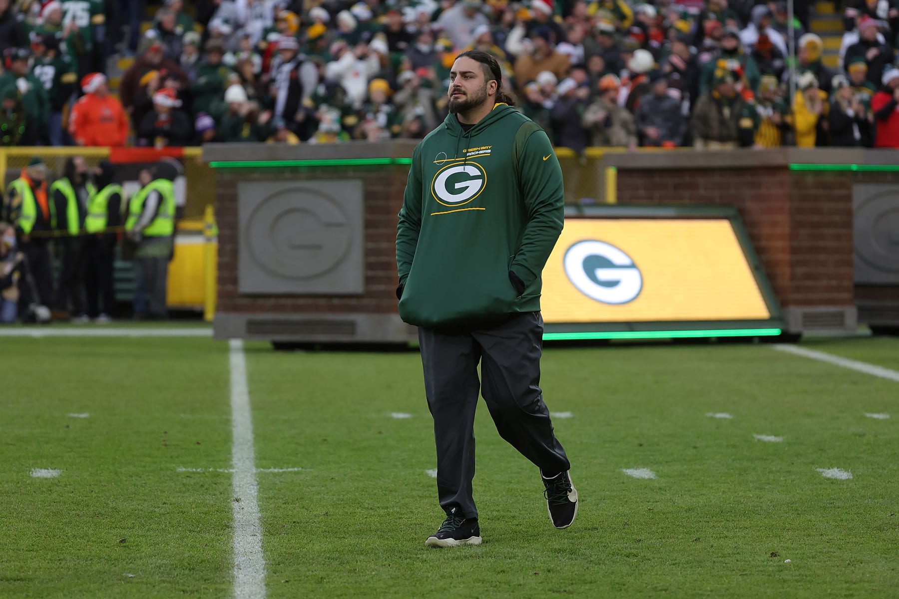 GREEN BAY, WISCONSIN - DECEMBER 25: David Bakhtiari #69 of the Green Bay Packers walks out duri player introductions prior to a game against the Cleveland Browns at Lambeau Field on December 25, 2021 in Green Bay, Wisconsin.  The Packers defeated the Browns 24-22. (Photo by Stacy Revere/Getty Images)