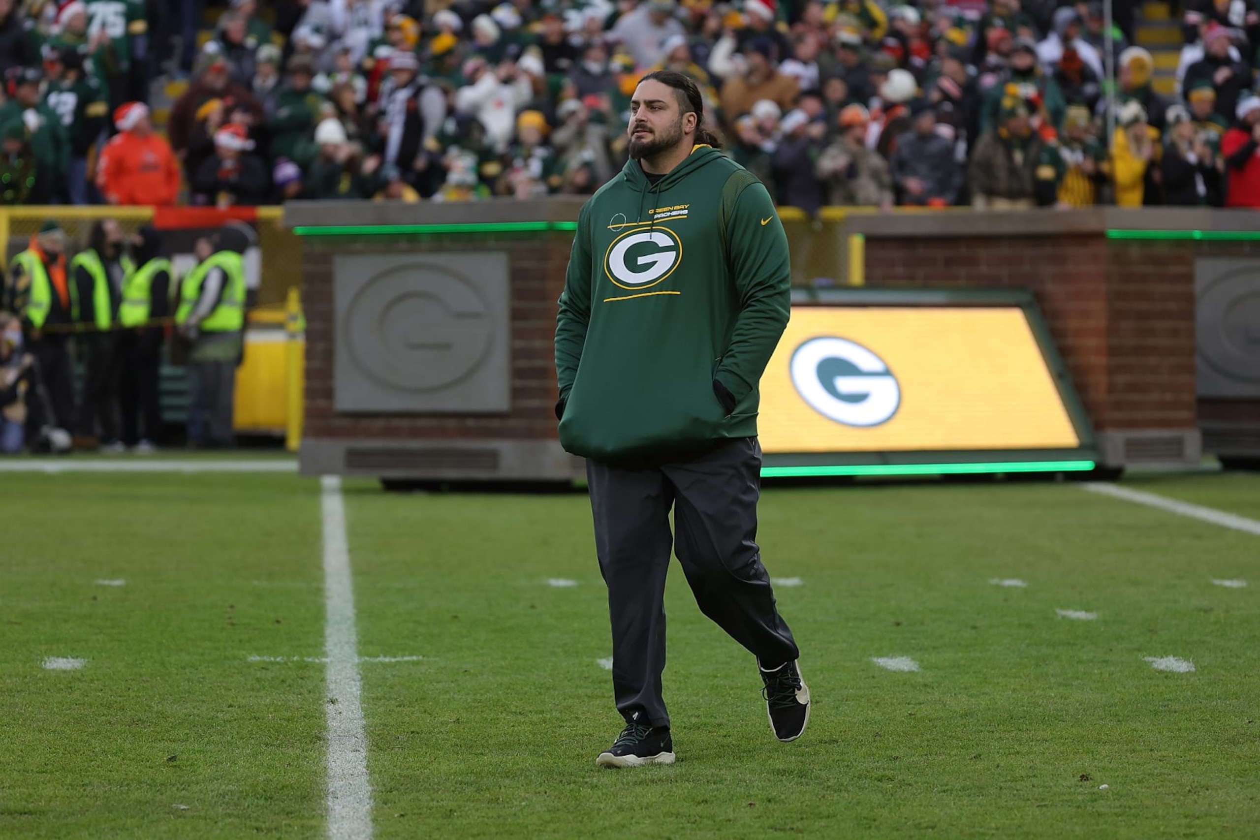 GREEN BAY, WISCONSIN - DECEMBER 25: David Bakhtiari #69 of the Green Bay Packers walks out duri player introductions prior to a game against the Cleveland Browns at Lambeau Field on December 25, 2021 in Green Bay, Wisconsin.  The Packers defeated the Browns 24-22. (Photo by Stacy Revere/Getty Images)