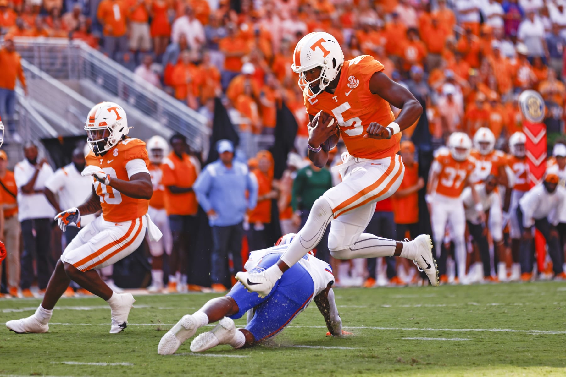 Tennessee quarterback Hendon Hooker (5) leaps over a Florida defender en route to a touchdown during the first half of an NCAA college football game Saturday, Sept. 24, 2022, in Knoxville, Tenn. (AP Photo/Wade Payne)
