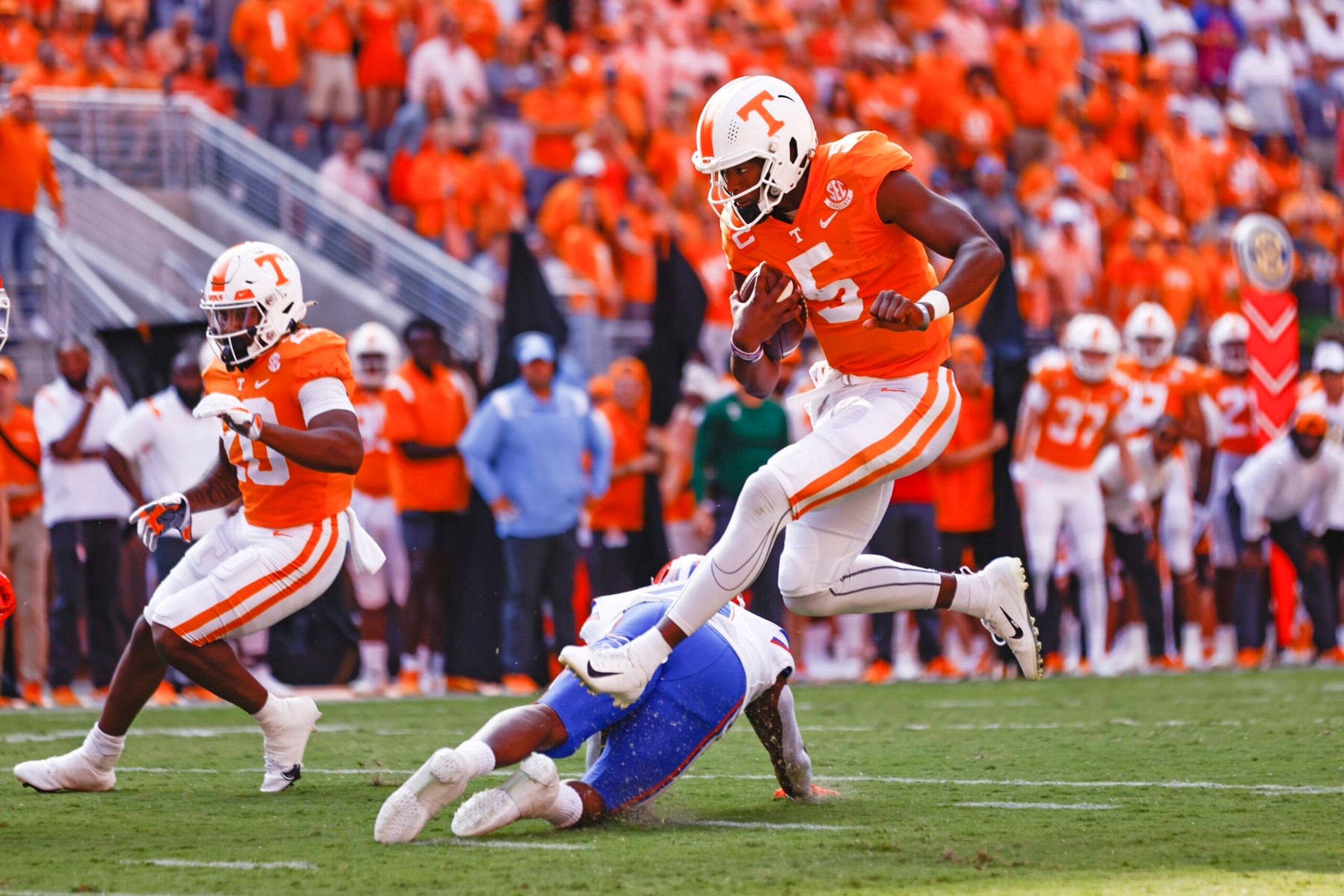 Tennessee quarterback Hendon Hooker (5) leaps over a Florida defender en route to a touchdown during the first half of an NCAA college football game Saturday, Sept. 24, 2022, in Knoxville, Tenn. (AP Photo/Wade Payne)