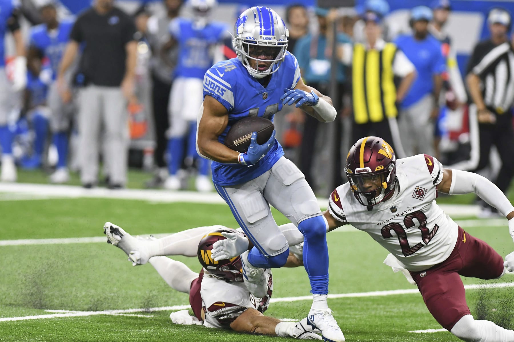 Detroit Lions wide receiver Amon-Ra St. Brown (14) runs after making a catch during the first half of an NFL football game against the Washington Commanders Sunday, Sept. 18, 2022, in Detroit. (AP Photo/Lon Horwedel)