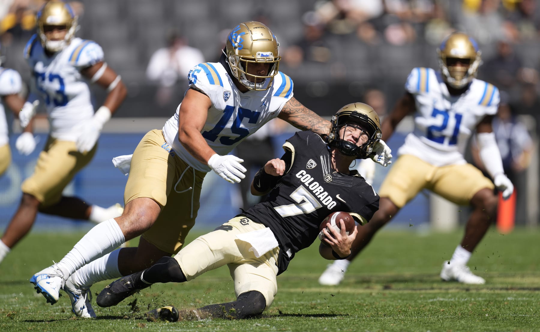 UCLA linebacker Laiatu Latu, left, sacks Colorado quarterback Owen McCown in the first half of an NCAA college football game Saturday, Sept. 24, 2022, in Boulder, Colo. (AP Photo/David Zalubowski)