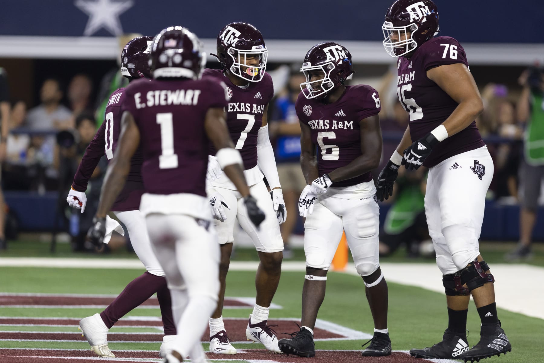 Texas A&M running back Devon Achane (6) is congratulated for his touchdown during the second half of the team's NCAA college football game against Arkansas on Saturday, Sept. 24, 2022, in Arlington, Texas. Texas A&M won 23-21. (AP Photo/Brandon Wade)