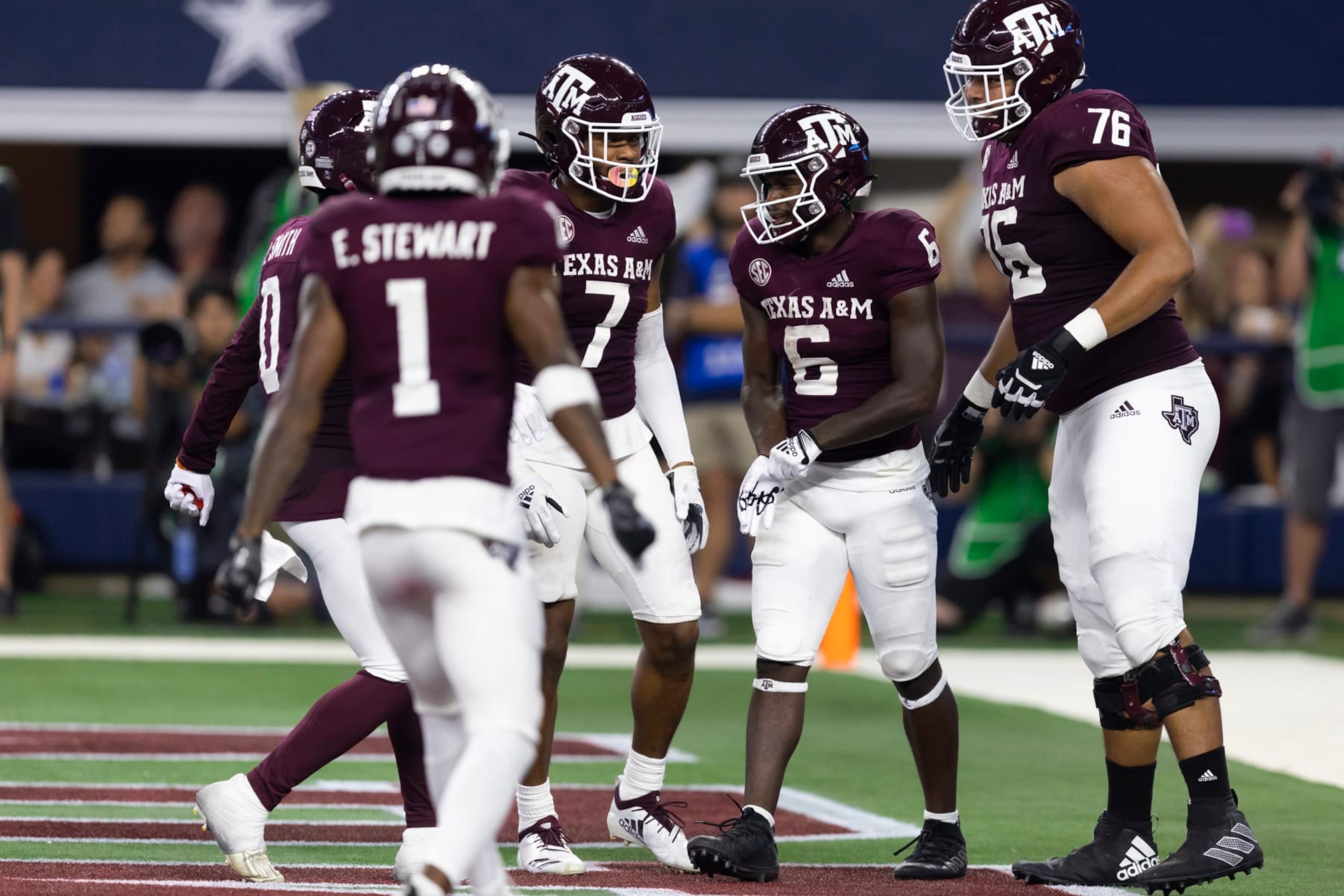 Texas A&M running back Devon Achane (6) is congratulated for his touchdown during the second half of the team's NCAA college football game against Arkansas on Saturday, Sept. 24, 2022, in Arlington, Texas. Texas A&M won 23-21. (AP Photo/Brandon Wade)