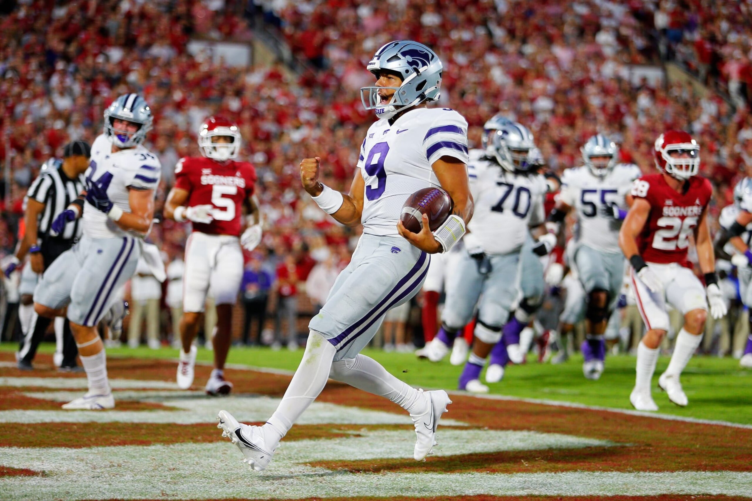 NORMAN, OK - SEPTEMBER 24: Quarterback Adrian Martinez #9 of the Kansas State Wildcats scores a touchdown on a 6-yard keeper against the Oklahoma Sooners in the first quarter at Gaylord Family Oklahoma Memorial Stadium on September 24, 2022 in Norman, Oklahoma. (Photo by Brian Bahr/Getty Images) NORMAN, OK - SEPTEMBER 24: Quarterback Adrian Martinez #9 of the Kansas State Wildcats scores a touchdown on a 6-yard keeper against the Oklahoma Sooners in the first quarter at Gaylord Family Oklahoma Memorial Stadium on September 24, 2022 in Norman, Oklahoma. (Photo by Brian Bahr/Getty Images)