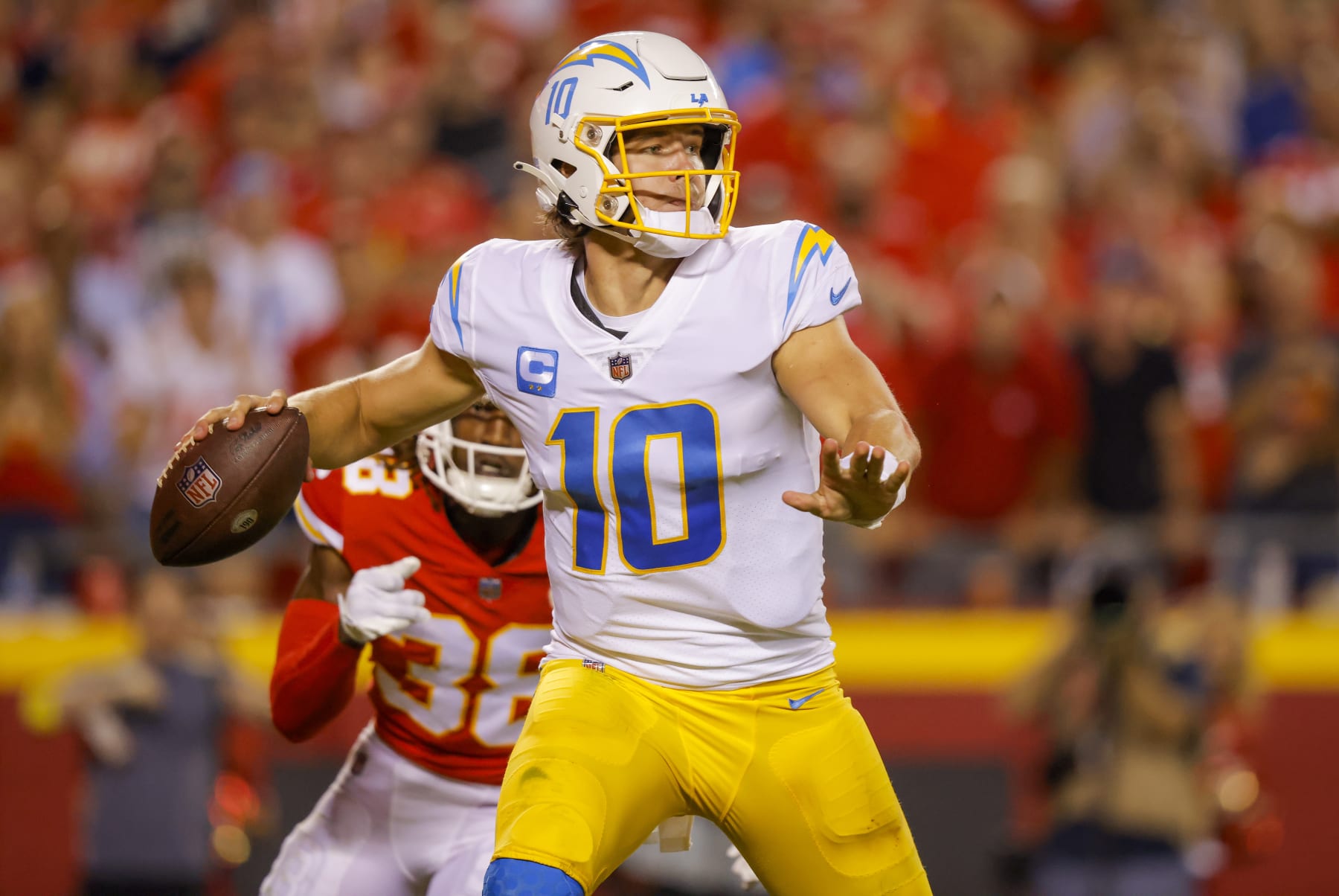 KANSAS CITY, MO - SEPTEMBER 15: Justin Herbert #10 of the Los Angeles Chargers throws a third quarter pass as L'Jarius Sneed #38 of the Kansas City Chiefs rushes at Arrowhead Stadium on September 15, 2022 in Kansas City, Missouri. (Photo by David Eulitt/Getty Images)