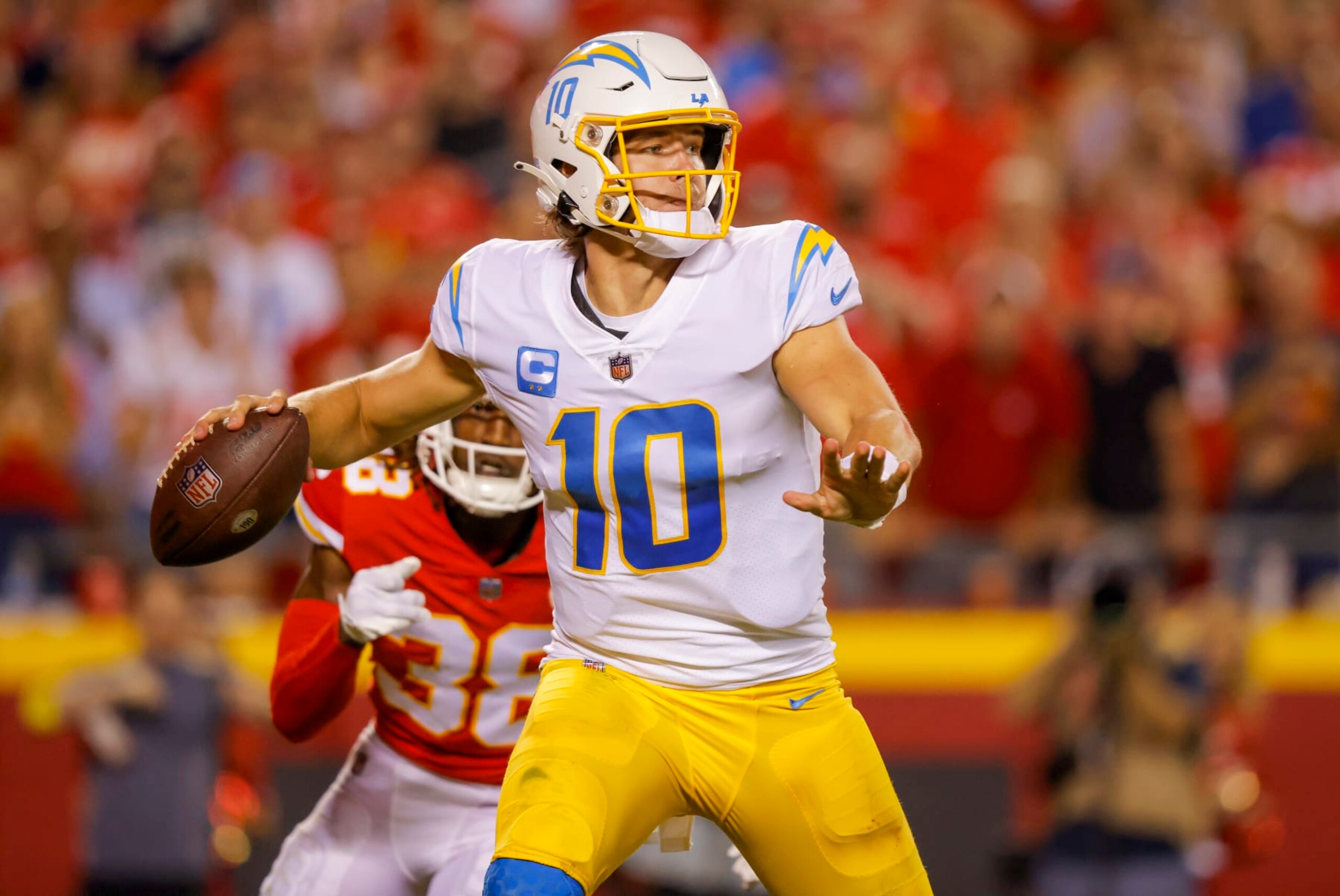 KANSAS CITY, MO - SEPTEMBER 15: Justin Herbert #10 of the Los Angeles Chargers throws a third quarter pass as L'Jarius Sneed #38 of the Kansas City Chiefs rushes at Arrowhead Stadium on September 15, 2022 in Kansas City, Missouri. (Photo by David Eulitt/Getty Images)