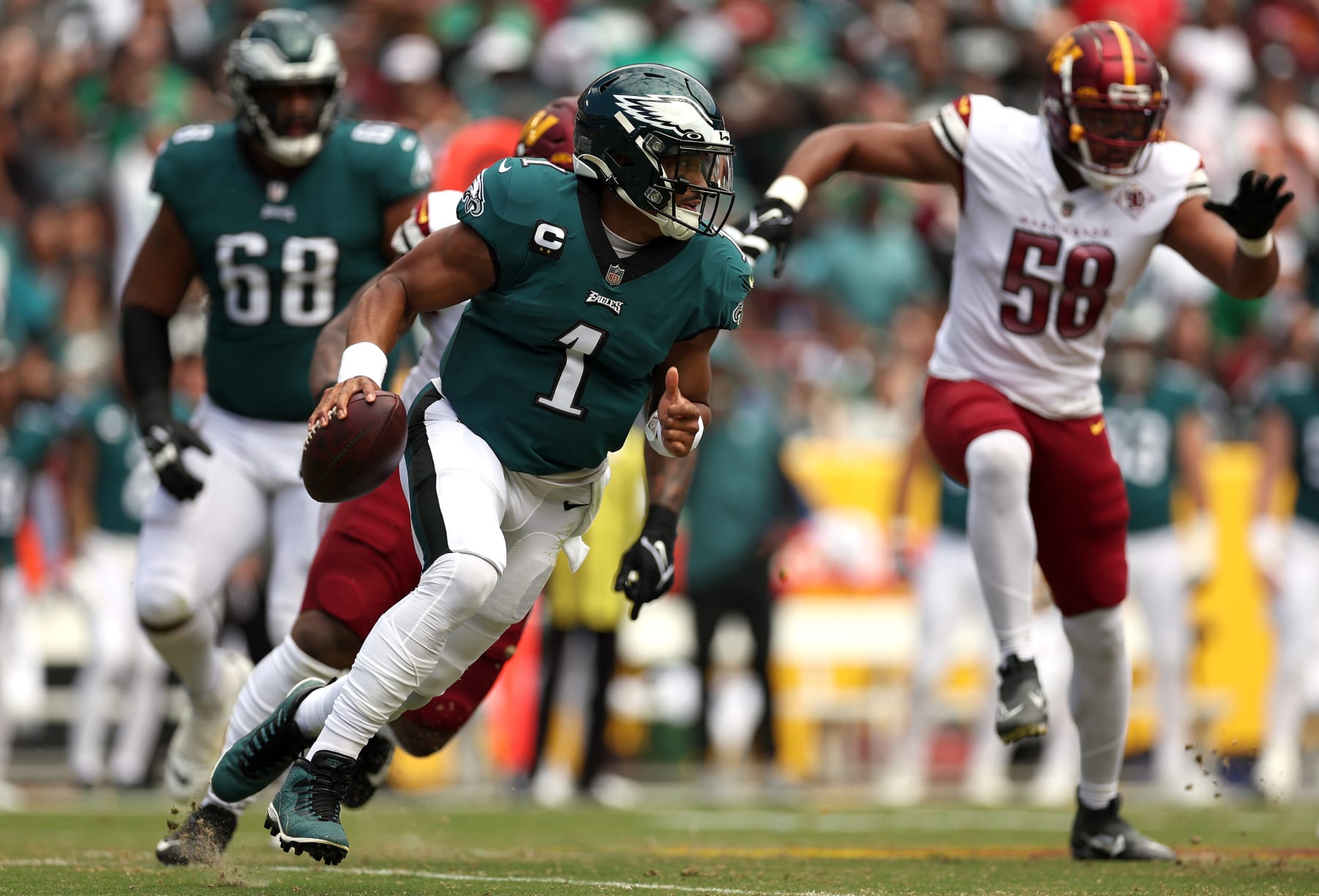 LANDOVER, MARYLAND - SEPTEMBER 25: Quarterback Jalen Hurts #1 of the Philadelphia Eagles scrambles during the first half at FedExField on September 25, 2022 in Landover, Maryland. (Photo by Scott Taetsch/Getty Images)