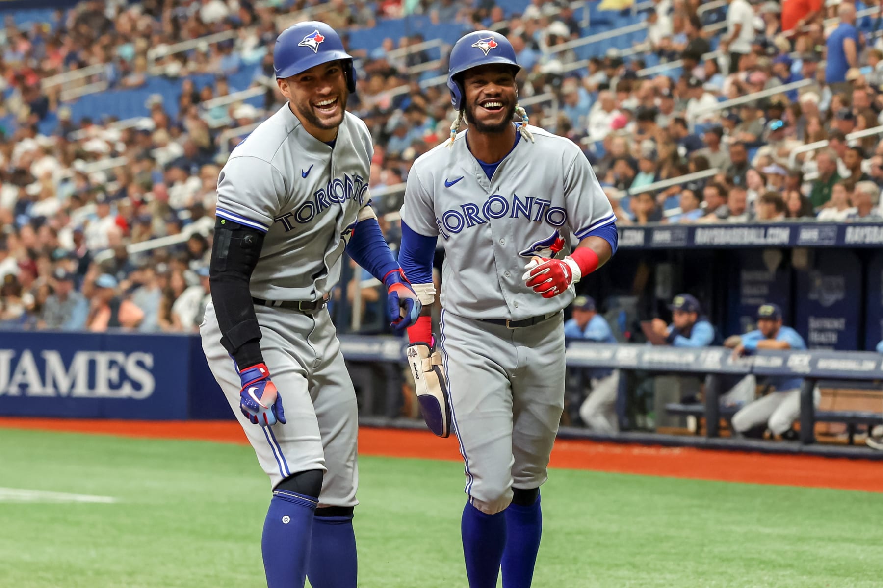 ST. PETERSBURG, FL - SEPTEMBER 25: George Springer #4 of the Toronto Blue Jays celebrates his home run against the Tampa Bay Rays with Raimel Tapia #15 in the third inning during a baseball game at Tropicana Field on September 25, 2022 in St. Petersburg, Florida. (Photo by Mike Carlson/Getty Images)