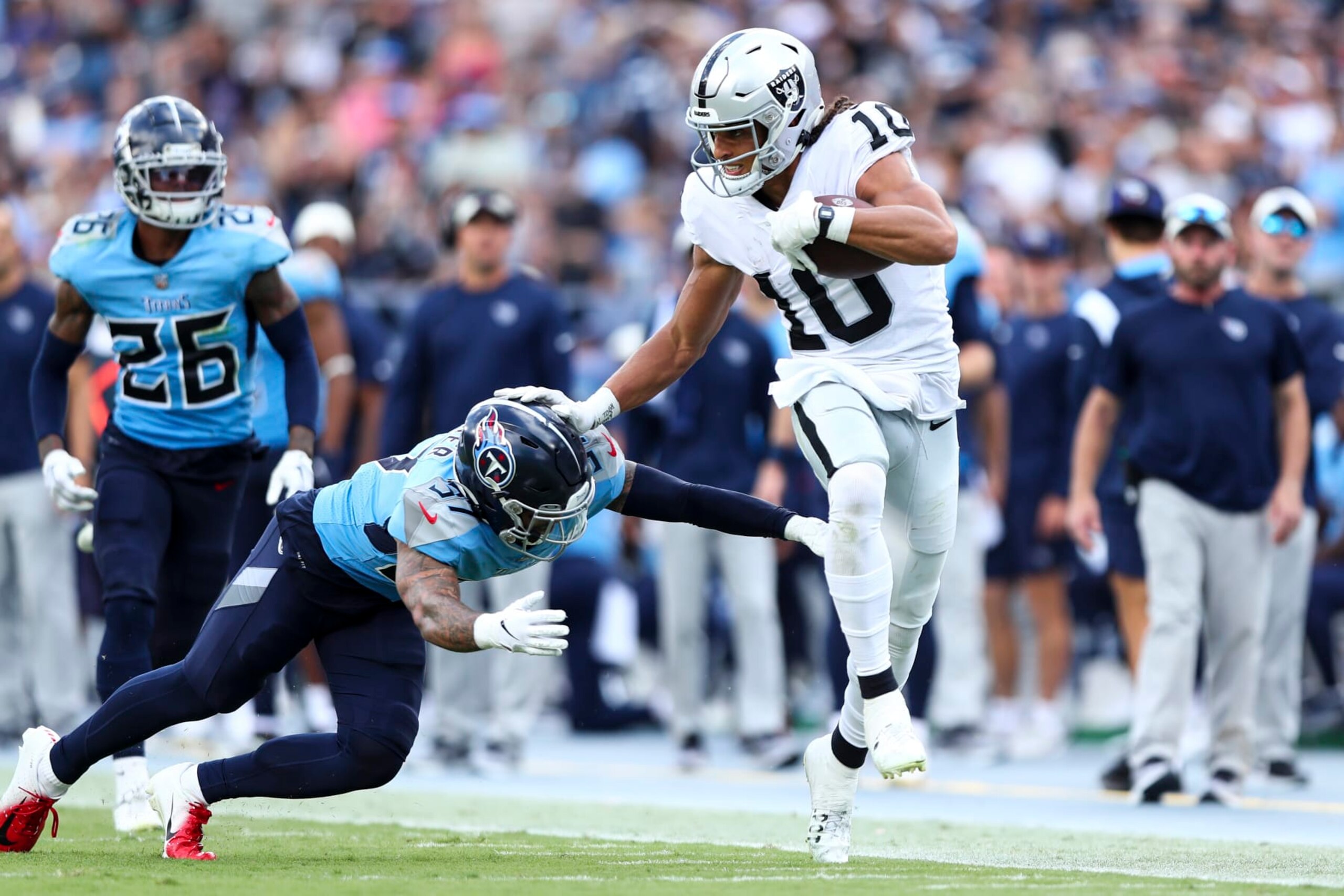NASHVILLE, TN - SEPTEMBER 25: Mack Hollins #10 of the Las Vegas Raiders stiff arms Amani Hooker #37 of the Tennessee Titans during an NFL football game at Nissan Stadium on September 25, 2022 in Nashville, Tennessee. (Photo by Kevin Sabitus/Getty Images)