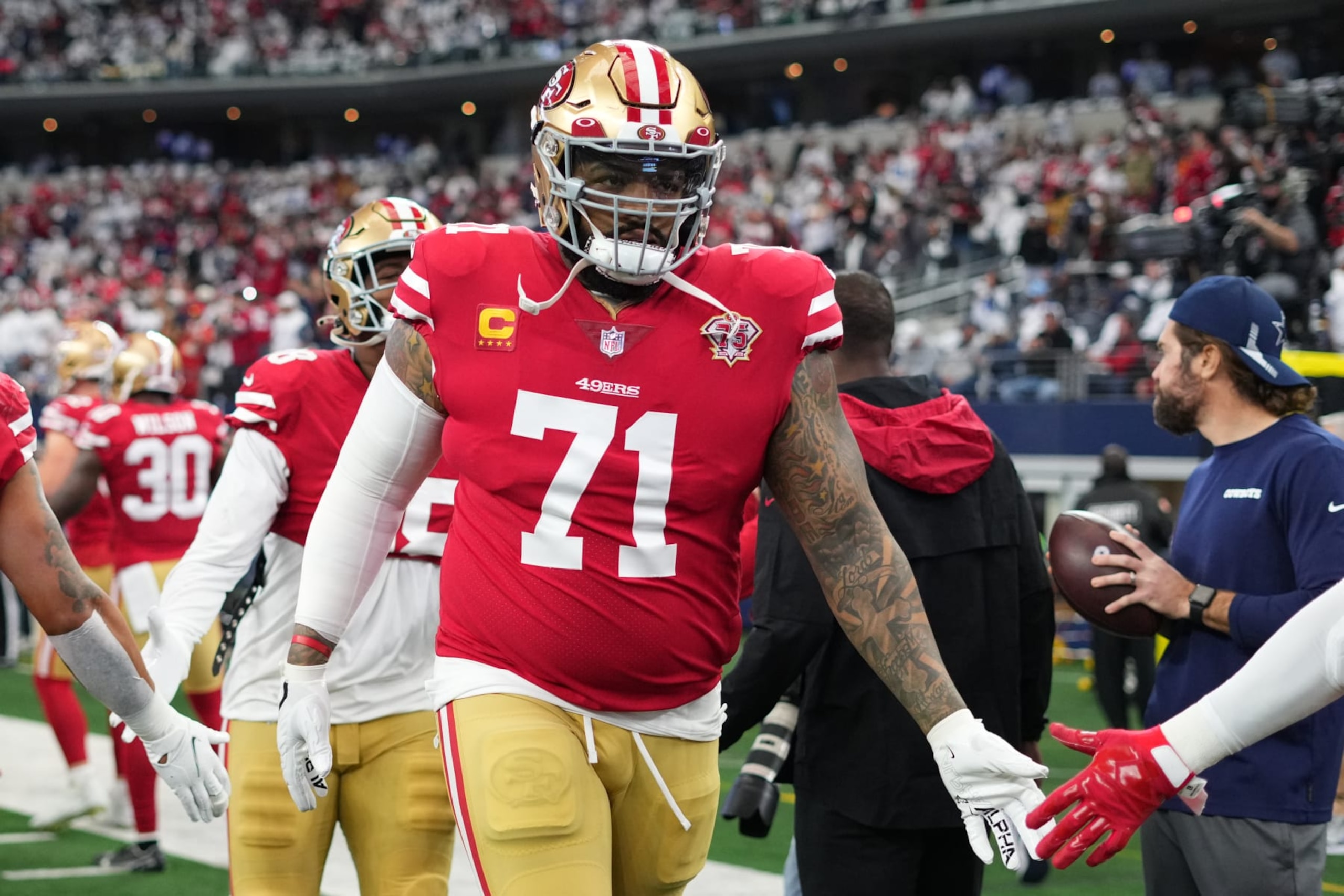 ARLINGTON, TEXAS - JANUARY 16: Trent Williams #71 of the San Francisco 49ers runs onto the field against the Dallas Cowboys prior to an NFL wild-card playoff football game at AT&T Stadium on January 16, 2022 in Arlington, Texas.  (Photo by Cooper Neill/Getty Images)