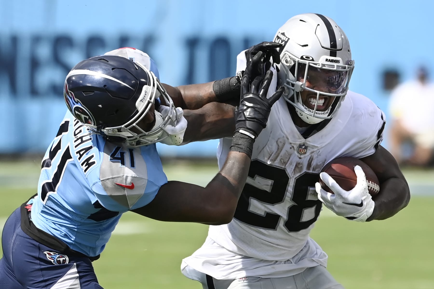Las Vegas Raiders running back Josh Jacobs (28) tries to get around Tennessee Titans linebacker Zach Cunningham (41) in the second half of an NFL football game Sunday, Sept. 25, 2022, in Nashville, Tenn. (AP Photo/Mark Zaleski)
