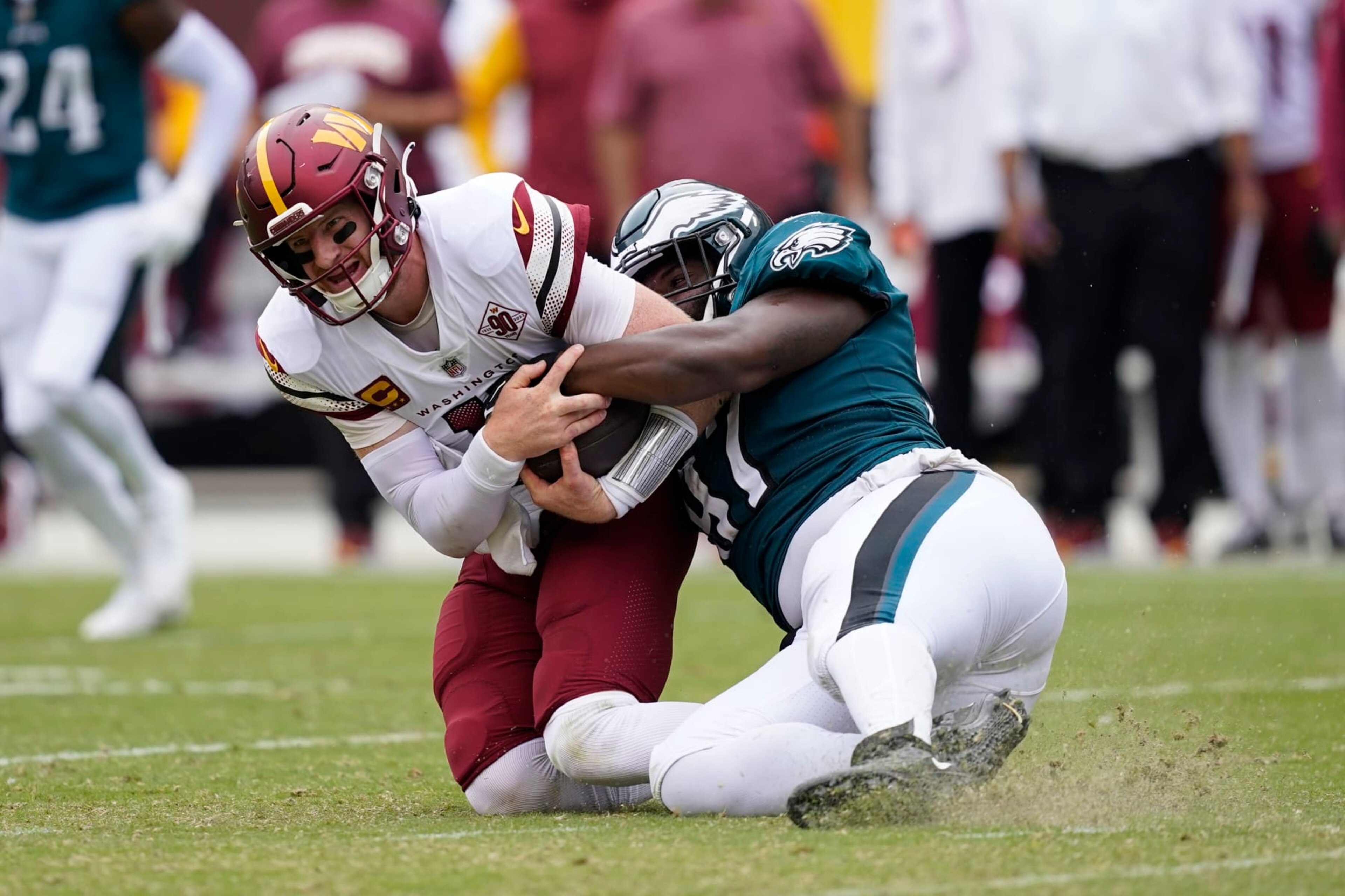 Philadelphia Eagles defensive tackle Javon Hargrave (97) pulls down Washington Commanders quarterback Carson Wentz (11) during the second half of an NFL football game, Sunday, Sept. 25, 2022, in Landover, Md. (AP Photo/Alex Brandon)