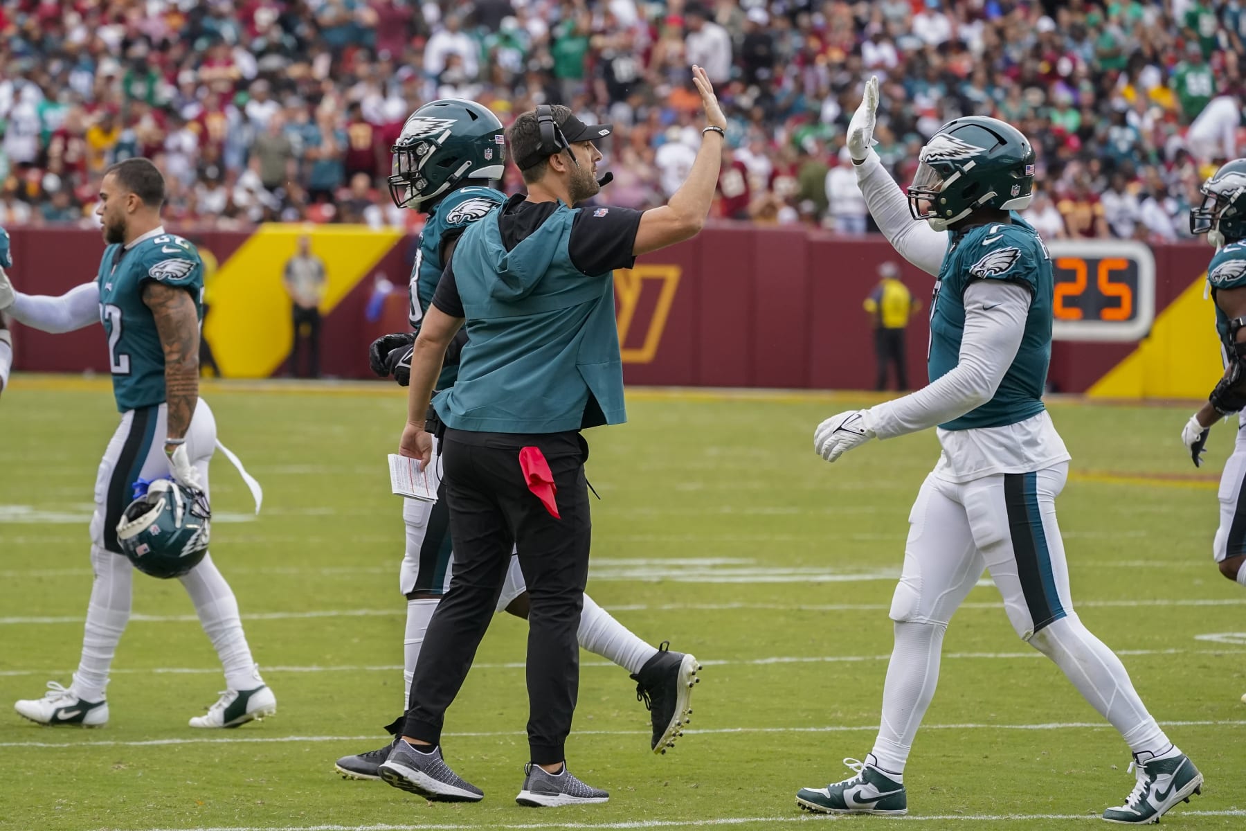 Philadelphia Eagles head coach Nick Sirianni, center, greeting linebacker Haason Reddick (7) during the second half of an NFL football game, Sunday, Sept. 25, 2022, in Landover, Md. (AP Photo/Alex Brandon)