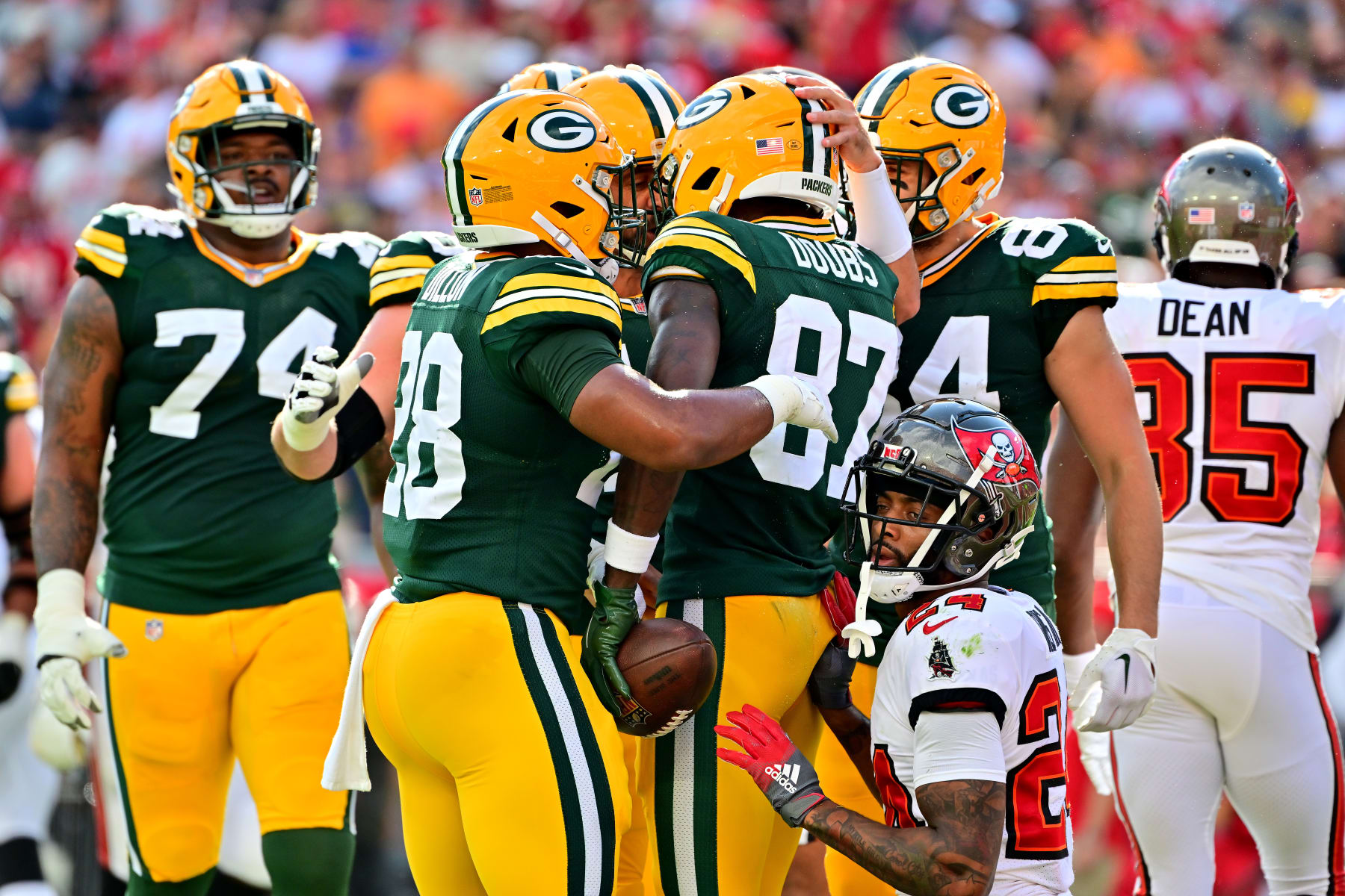 TAMPA, FLORIDA - SEPTEMBER 25: Romeo Doubs #87 of the Green Bay Packers celebrates with his teammates after scoring a touchdown against the Tampa Bay Buccaneers during the first quarter in the game at Raymond James Stadium on September 25, 2022 in Tampa, Florida. (Photo by Julio Aguilar/Getty Images)