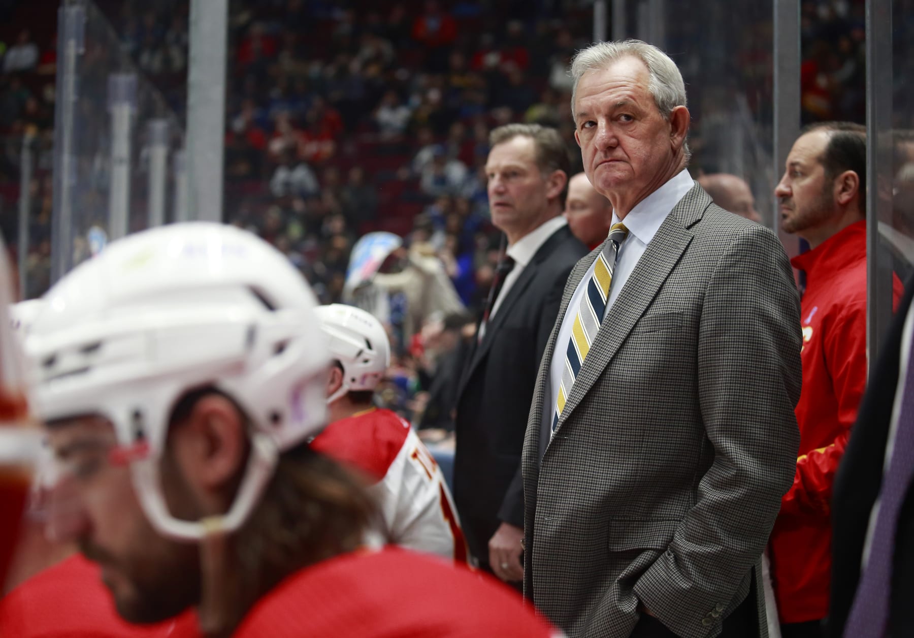 VANCOUVER, BC - MARCH 19: Head coach Darryl Sutter of the Calgary Flames looks on from the bench during their NHL game against the Vancouver Canucks at Rogers Arena March 19, 2022 in Vancouver, British Columbia, Canada.  (Photo by Jeff Vinnick/NHLI via Getty Images)"n