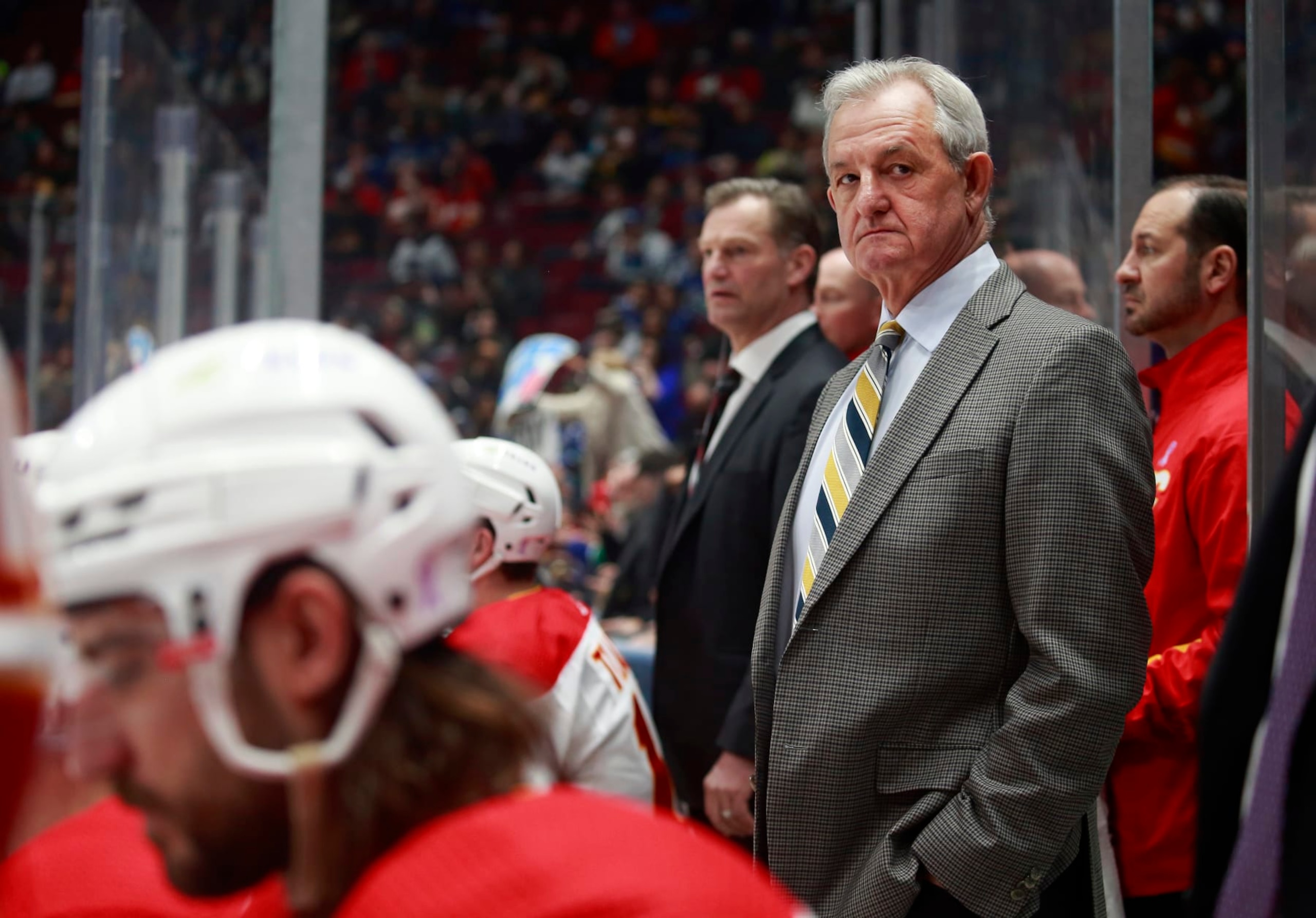 VANCOUVER, BC - MARCH 19: Head coach Darryl Sutter of the Calgary Flames looks on from the bench during their NHL game against the Vancouver Canucks at Rogers Arena March 19, 2022 in Vancouver, British Columbia, Canada.  (Photo by Jeff Vinnick/NHLI via Getty Images)"n