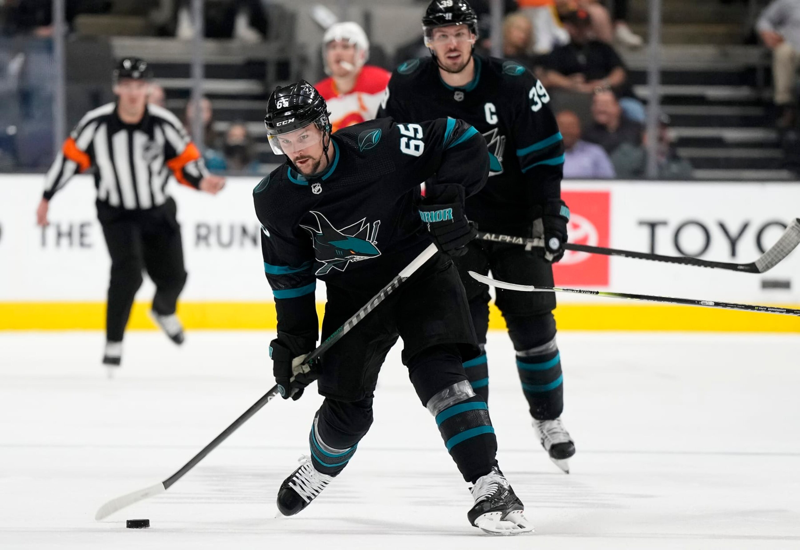 SAN JOSE, CALIFORNIA - APRIL 07: Erik Karlsson #65 of the San Jose Sharks shoots on goal against the Calgary Flames during the second period of an NHL hockey game at SAP Center on April 07, 2022 in San Jose, California. (Photo by Thearon W. Henderson/Getty Images)