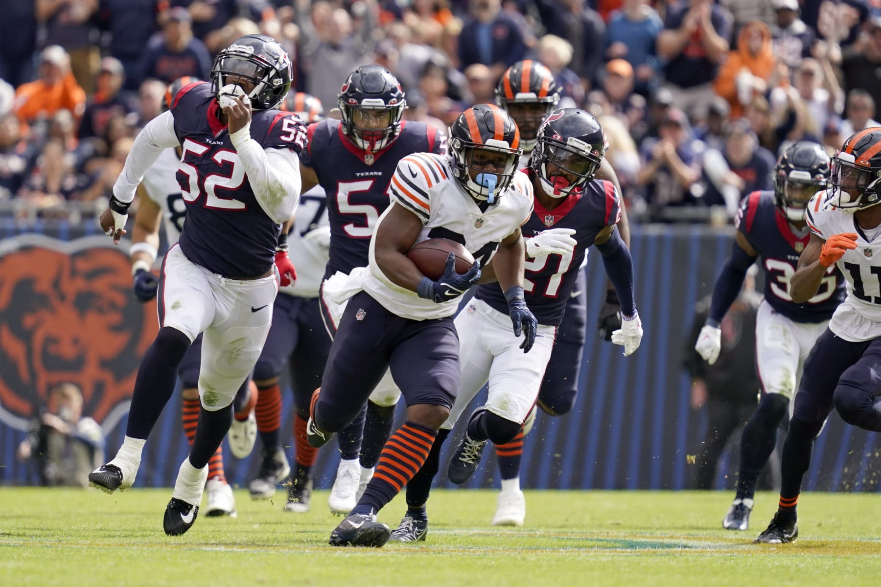 Chicago Bears running back Khalil Herbert, center, runs for a gain of 52 yards as Houston Texans defenders chase him during the second half of an NFL football game Sunday, Sept. 25, 2022, in Chicago. (AP Photo/Nam Y. Huh)