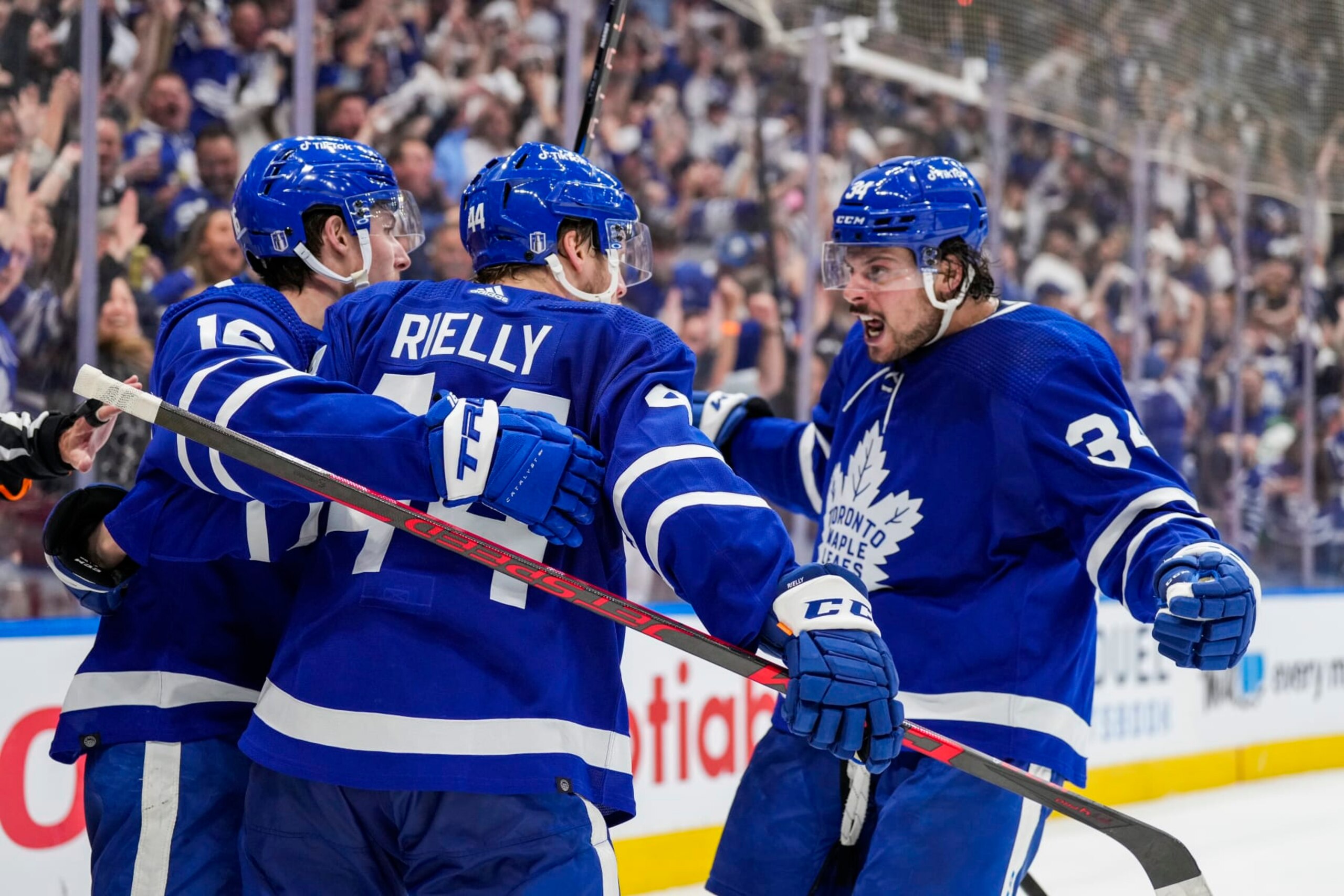 TORONTO, ON - MAY 14: Morgan Rielly #44 of the Toronto Maple Leafs celebrates his goal against the Tampa Bay Lightning with teammates Mitch Marner #16 and Auston Matthews #34 during the second period in Game Seven of the First Round of the 2022 Stanley Cup Playoffs at the Scotiabank Arena on May 14, 2022 in Toronto, Ontario, Canada. (Photo by Kevin Sousa/NHLI via Getty Images)