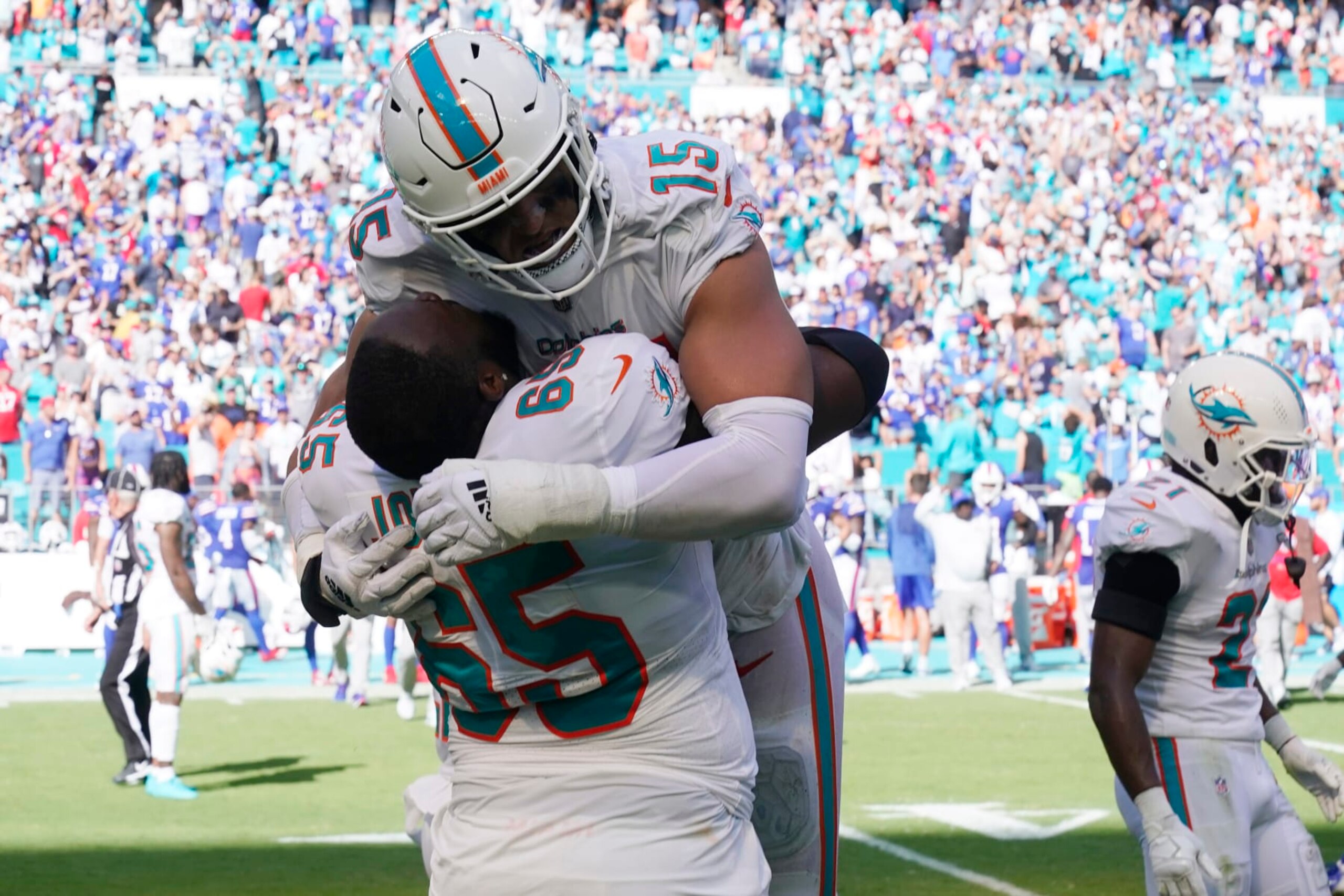 Miami Dolphins linebacker Jaelan Phillips (15) and guard Robert Jones (65) hug at the end of an NFL football game against the Buffalo Bills, Sunday, Sept. 25, 2022, in Miami Gardens, Fla. The Dolphins defeated the Bills 21-19. (AP Photo/Wilfredo Lee ) Miami Dolphins linebacker Jaelan Phillips (15) and guard Robert Jones (65) hug at the end of an NFL football game against the Buffalo Bills, Sunday, Sept. 25, 2022, in Miami Gardens, Fla. The Dolphins defeated the Bills 21-19. (AP Photo/Wilfredo Lee )