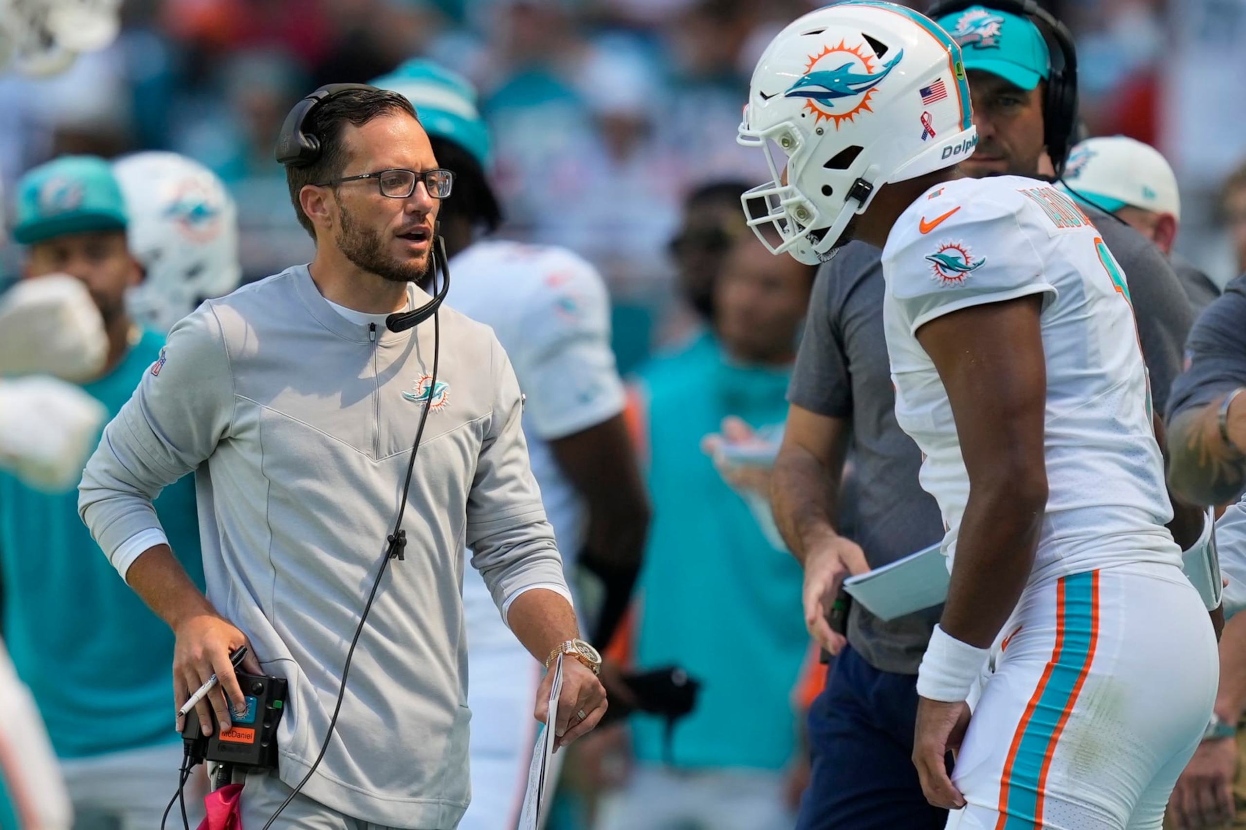 Miami Dolphins head coach Mike McDaniel talks to quarterback Tua Tagovailoa (1) during the second half of an NFL football game against the New England Patriots, Sunday, Sept. 11, 2022, in Miami Gardens, Fla. (AP Photo/Rebecca Blackwell) Miami Dolphins head coach Mike McDaniel talks to quarterback Tua Tagovailoa (1) during the second half of an NFL football game against the New England Patriots, Sunday, Sept. 11, 2022, in Miami Gardens, Fla. (AP Photo/Rebecca Blackwell)