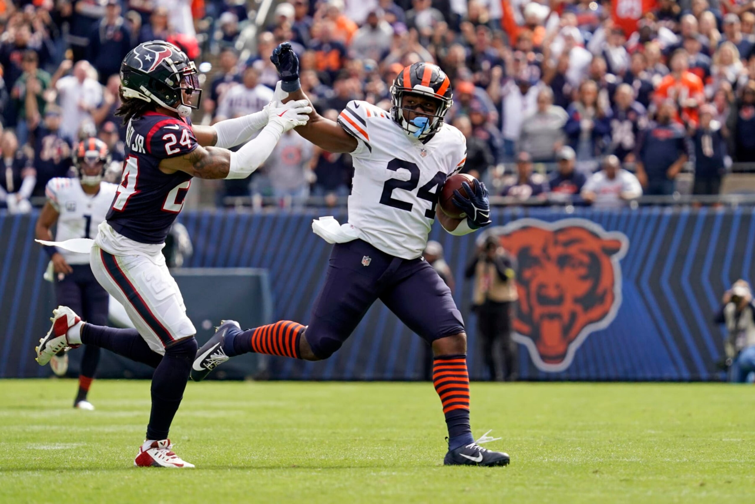Houston Texans cornerback Derek Stingley Jr., left, reaches to tackle Chicago Bears running back Khalil Herbert during the second half of an NFL football game Sunday, Sept. 25, 2022, in Chicago. (AP Photo/Nam Y. Huh)