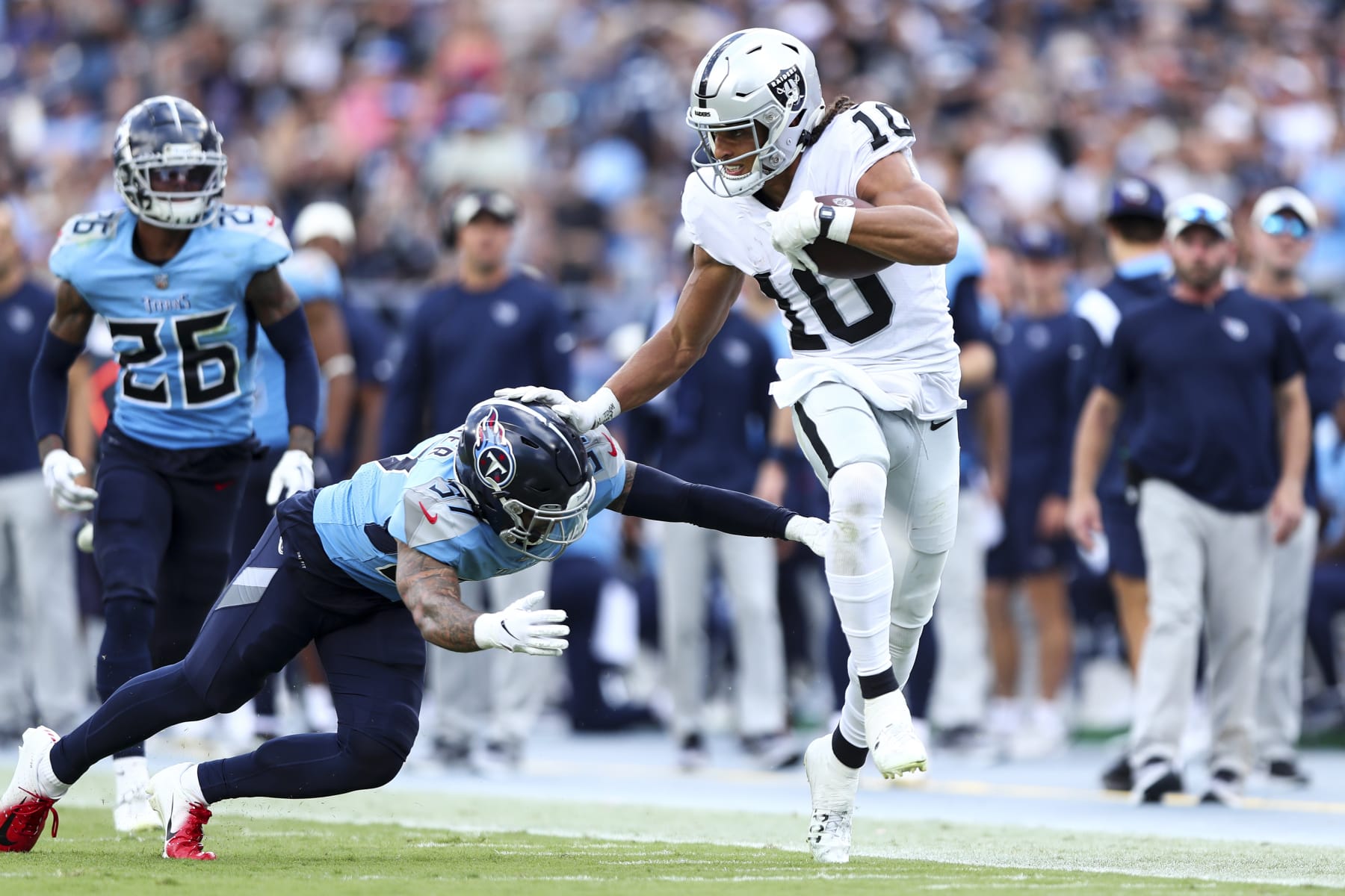 NASHVILLE, TN - SEPTEMBER 25: Mack Hollins #10 of the Las Vegas Raiders stiff arms Amani Hooker #37 of the Tennessee Titans during an NFL football game at Nissan Stadium on September 25, 2022 in Nashville, Tennessee. (Photo by Kevin Sabitus/Getty Images)