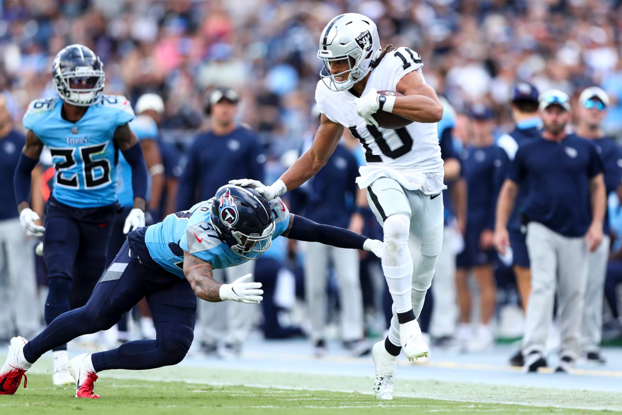 NASHVILLE, TN - SEPTEMBER 25: Mack Hollins #10 of the Las Vegas Raiders stiff arms Amani Hooker #37 of the Tennessee Titans during an NFL football game at Nissan Stadium on September 25, 2022 in Nashville, Tennessee. (Photo by Kevin Sabitus/Getty Images)