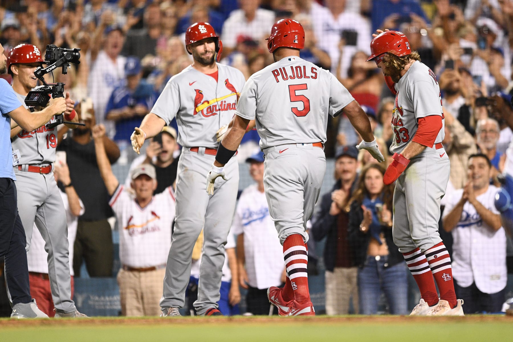 LOS ANGELES, CA - SEPTEMBER 23: St. Louis Cardinals designated hitter Albert Pujols (5) is greeted by St. Louis Cardinals second baseman Brendan Donovan (33) and St. Louis Cardinals first baseman Paul Goldschmidt (46) after hitting career home run number 700 during the MLB game between the St. Louis Cardinals and the Los Angeles Dodgers on September 23, 2022 at Dodger Stadium in Los Angeles, CA. (Photo by Brian Rothmuller/Icon Sportswire via Getty Images)
