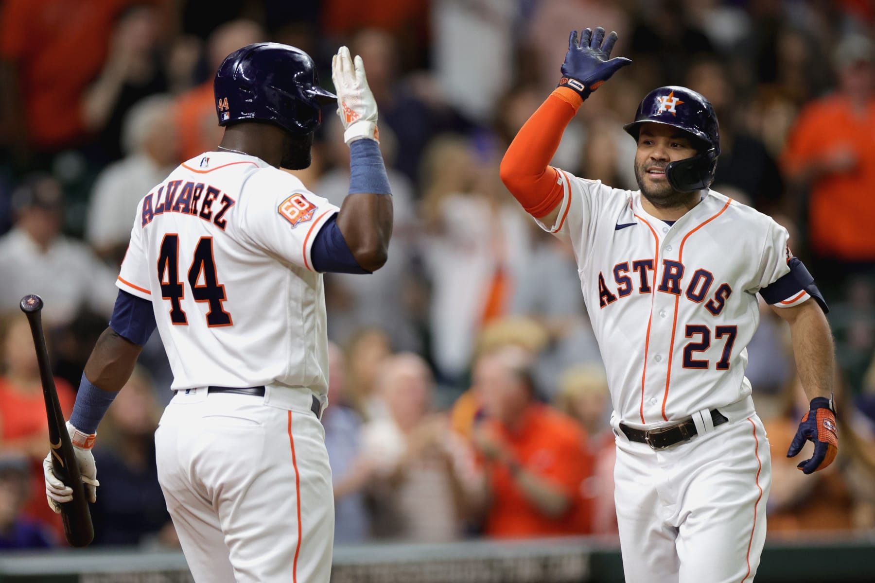 HOUSTON, TEXAS - SEPTEMBER 06: Jose Altuve #27 of the Houston Astros high fives Yordan Alvarez #44 after hitting a solo home run during the third inning against the Texas Rangers at Minute Maid Park on September 06, 2022 in Houston, Texas. (Photo by Carmen Mandato/Getty Images)