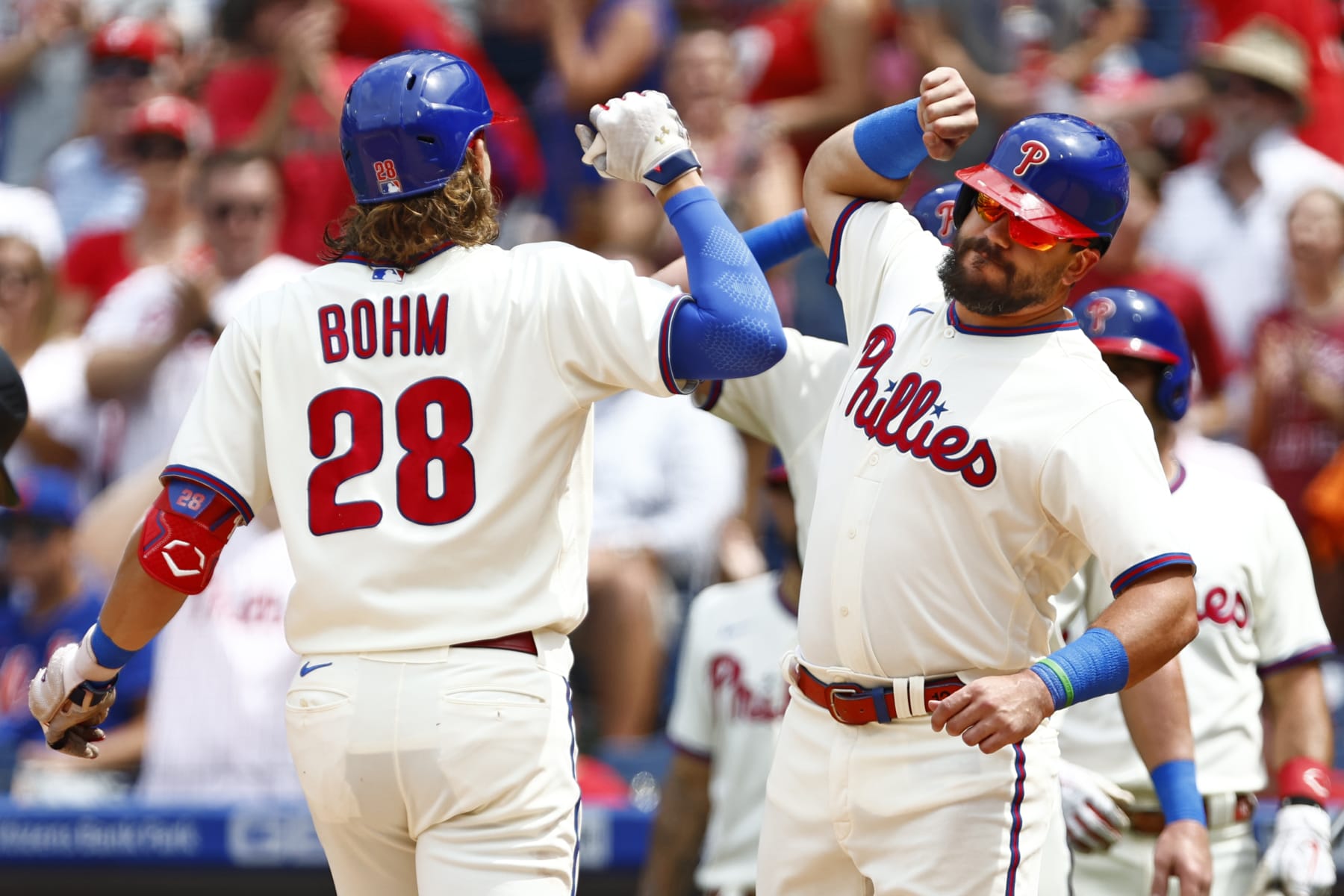 PHILADELPHIA, PA - AUGUST 21: Alec Bohm #28 of the Philadelphia Phillies is congratulated Kyle Schwarber #12 after he hit a three-run home run against the New York Mets during the first inning of a game at Citizens Bank Park on August 21, 2022 in Philadelphia, Pennsylvania. (Photo by Rich Schultz/Getty Images)