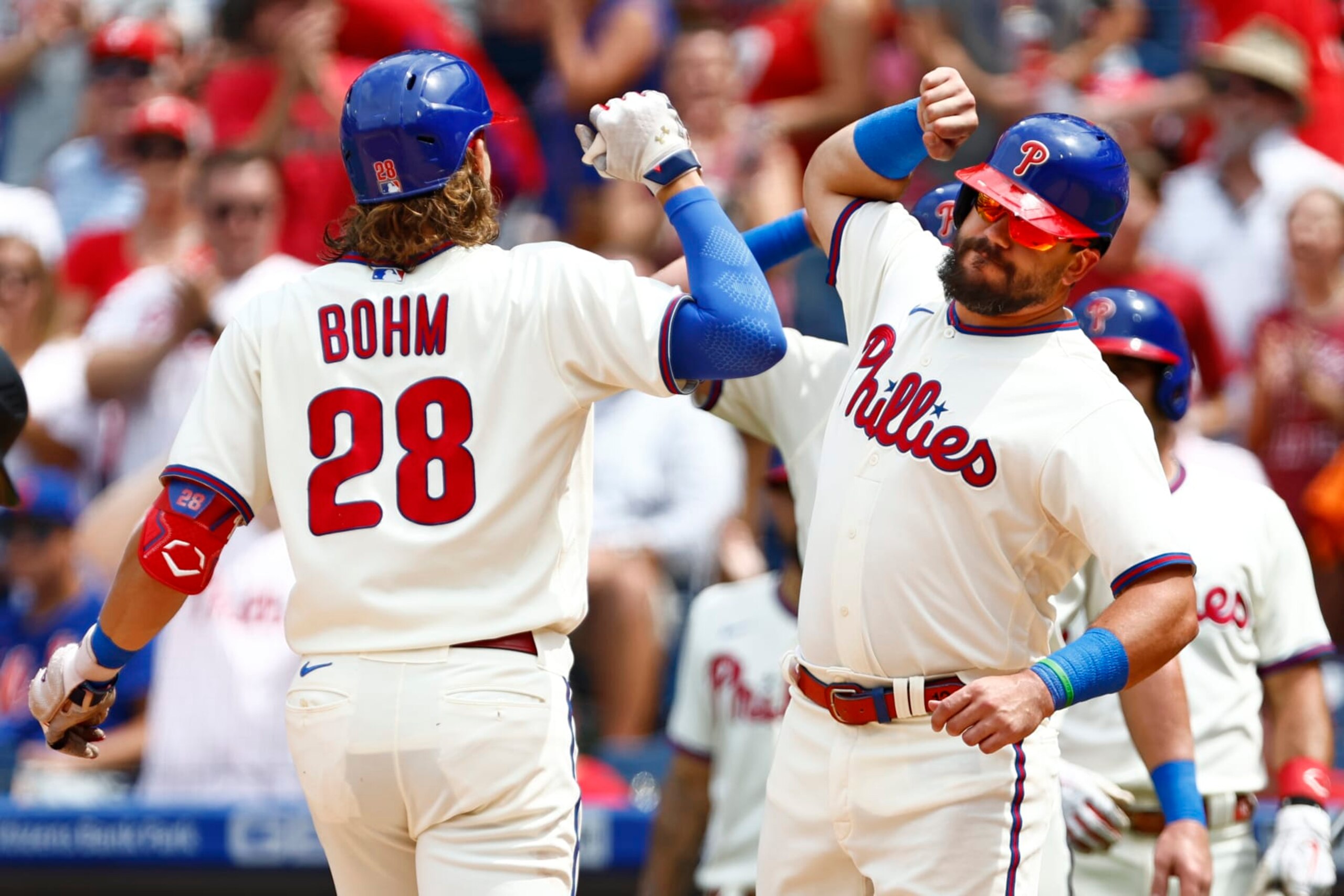 PHILADELPHIA, PA - AUGUST 21: Alec Bohm #28 of the Philadelphia Phillies is congratulated Kyle Schwarber #12 after he hit a three-run home run against the New York Mets during the first inning of a game at Citizens Bank Park on August 21, 2022 in Philadelphia, Pennsylvania. (Photo by Rich Schultz/Getty Images)