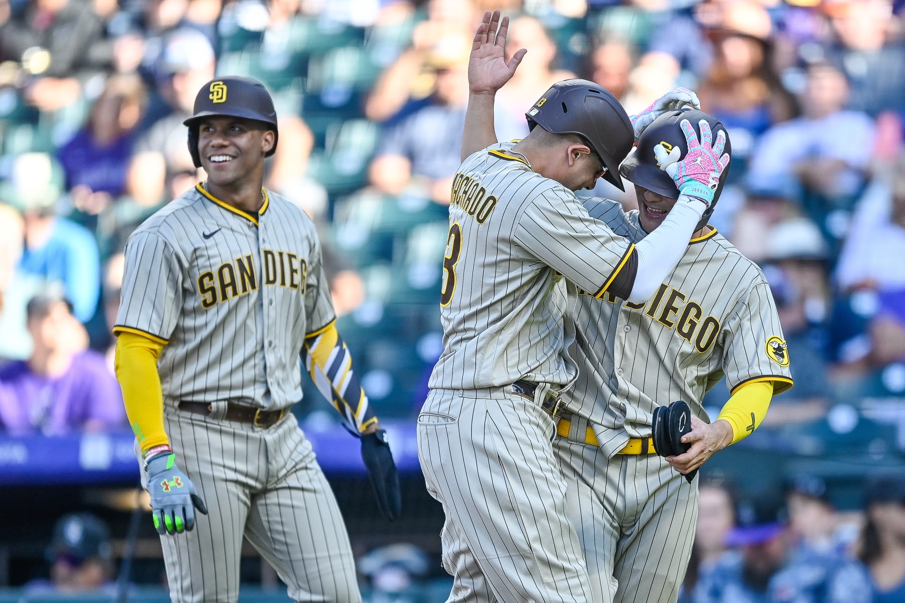 DENVER, CO - SEPTEMBER 25: Manny Machado #13 of the San Diego Padres celebrates with Ha-Seong Kim #7 and Juan Soto #22 after hitting an eighth inning three run home run against the Colorado Rockies at Coors Field on September 25, 2022 in Denver, Colorado. (Photo by Dustin Bradford/Getty Images)