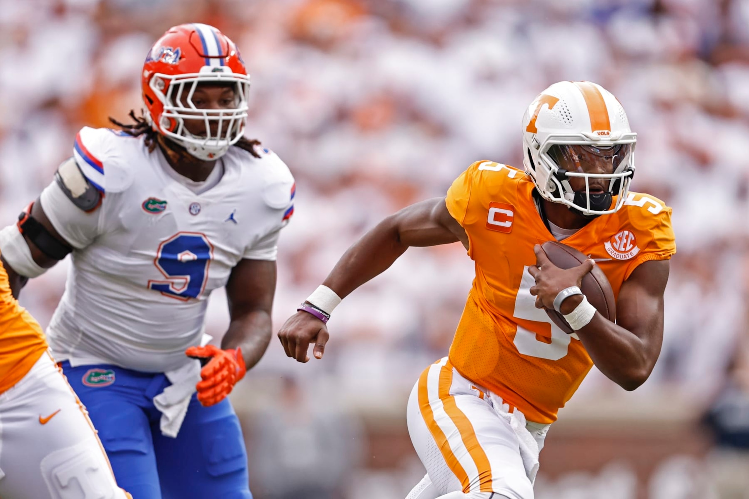Tennessee quarterback Hendon Hooker (5) runs for yardages as he's chased by Florida defensive lineman Gervon Dexter Sr. (9) during the first half of an NCAA college football game Saturday, Sept. 24, 2022, in Knoxville, Tenn. (AP Photo/Wade Payne) Tennessee quarterback Hendon Hooker (5) runs for yardages as he's chased by Florida defensive lineman Gervon Dexter Sr. (9) during the first half of an NCAA college football game Saturday, Sept. 24, 2022, in Knoxville, Tenn. (AP Photo/Wade Payne)