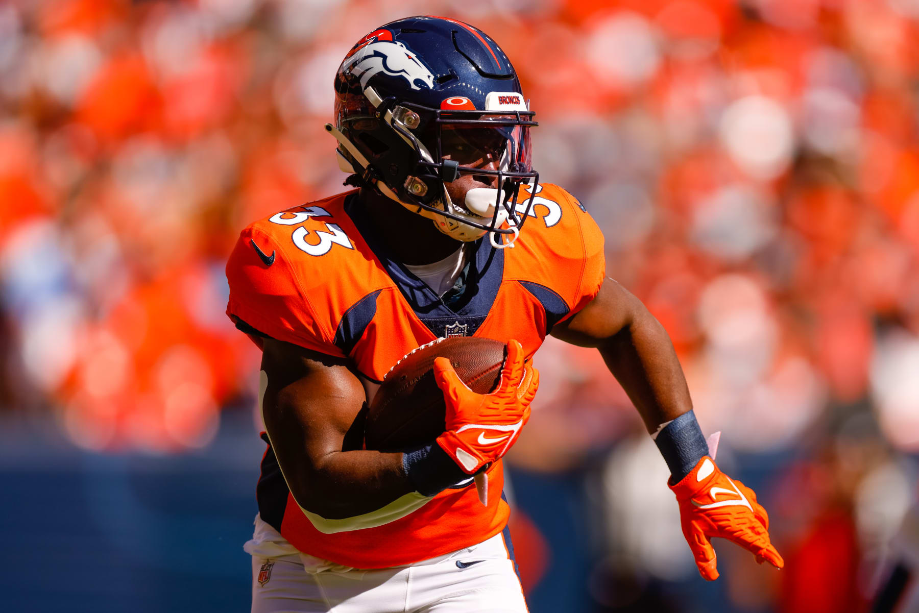 DENVER, CO - SEPTEMBER 18:  Running back Javonte Williams #33 of the Denver Broncos runs with the football during the first quarter against the Houston Texans at Empower Field at Mile High on September 18, 2022 in Denver, Colorado. (Photo by Justin Edmonds/Getty Images)