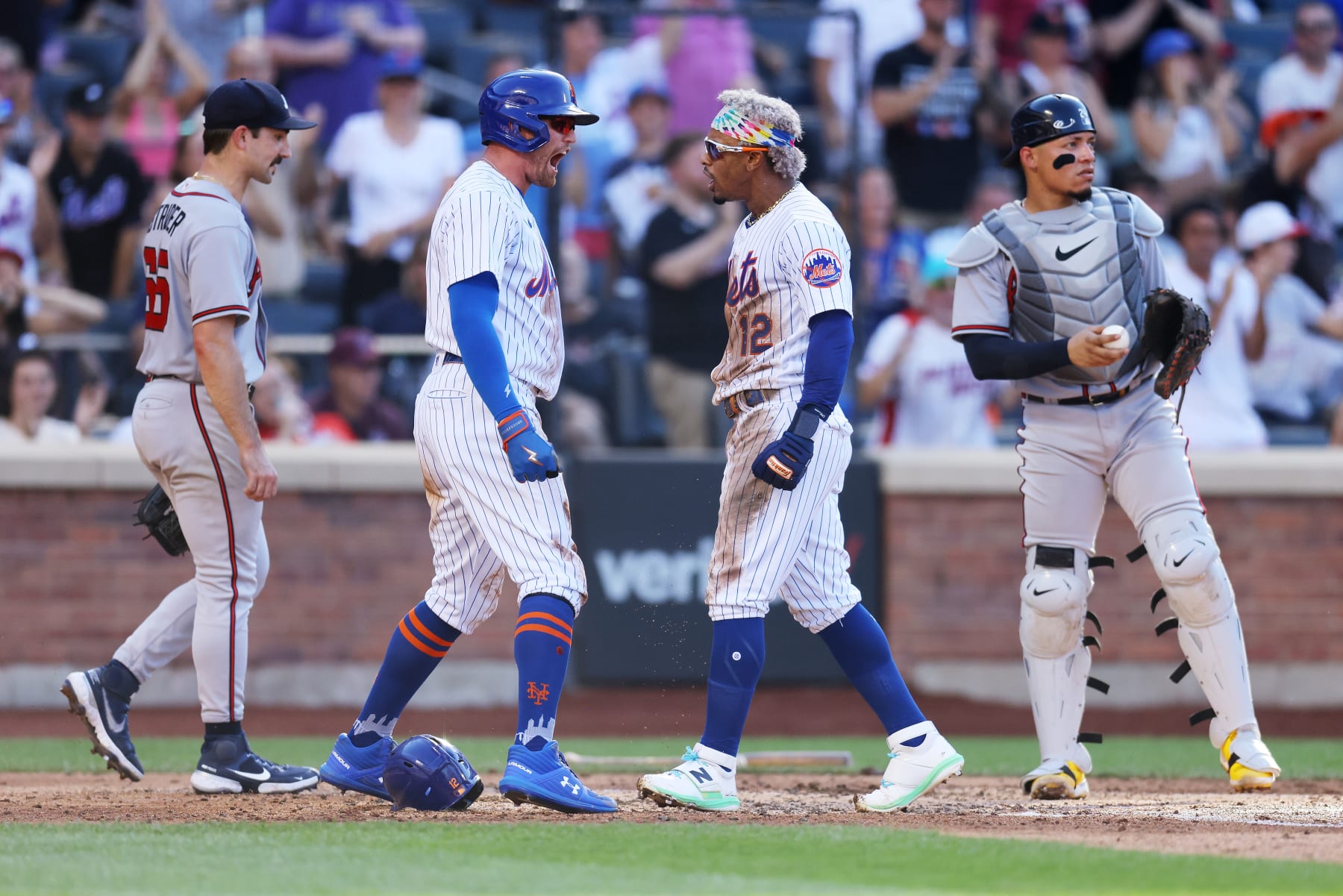 NEW YORK, NEW YORK - AUGUST 07: Francisco Lindor #12 and Brandon Nimmo #9 of the New York Mets celebrates after scoring on Pete Alonso #20 2-run double in the third inning as Spencer Strider #65 and William Contreras #24 of the Atlanta Braves look on against the Atlanta Braves at Citi Field on August 07, 2022 in New York City. (Photo by Mike Stobe/Getty Images)