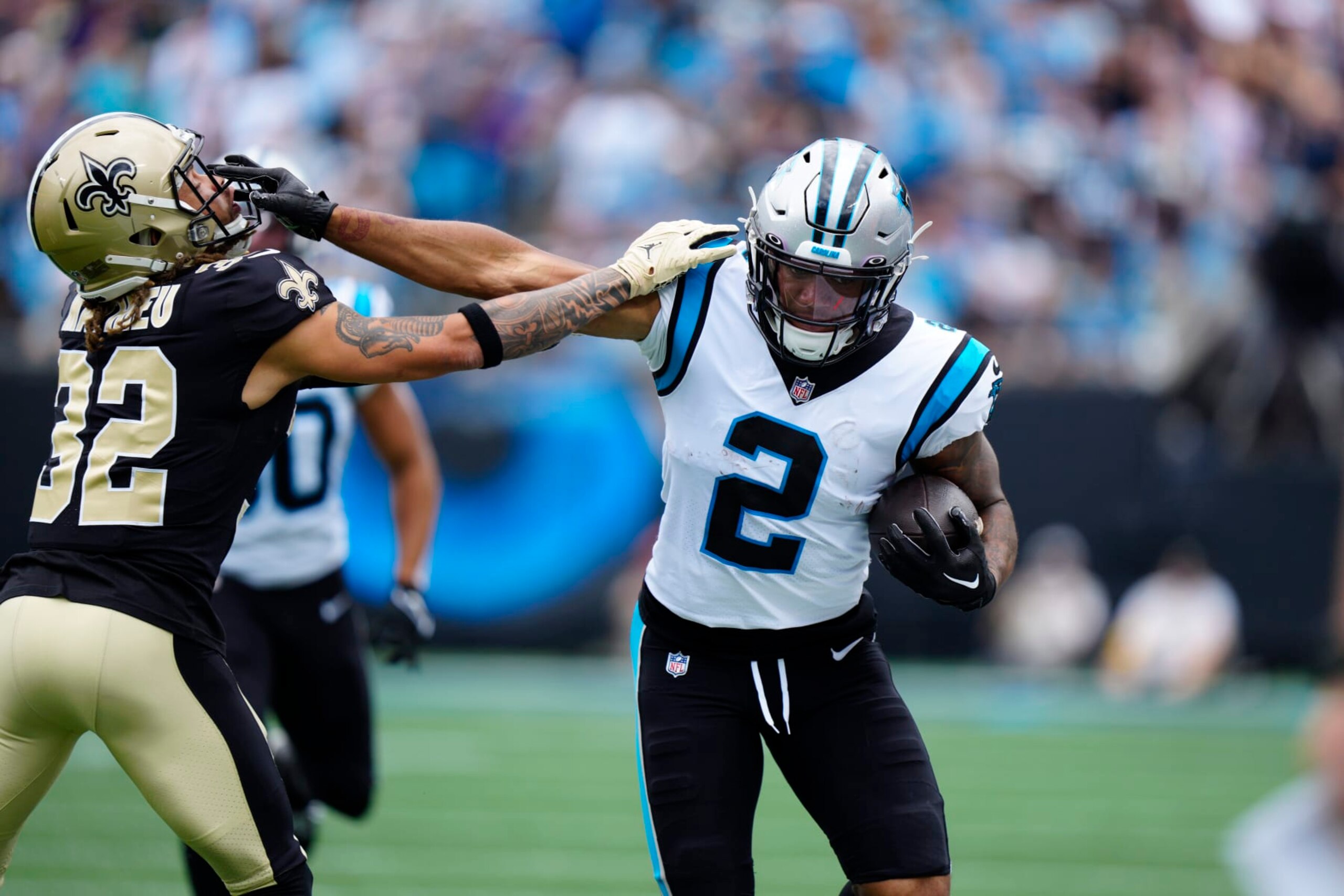 Carolina Panthers wide receiver DJ Moore (2) keeps the ball away from New Orleans Saints safety Tyrann Mathieu (32) during the first half of an NFL football game, Sunday, Sept. 25, 2022, in Charlotte, N.C. (AP Photo/Jacob Kupferman)
