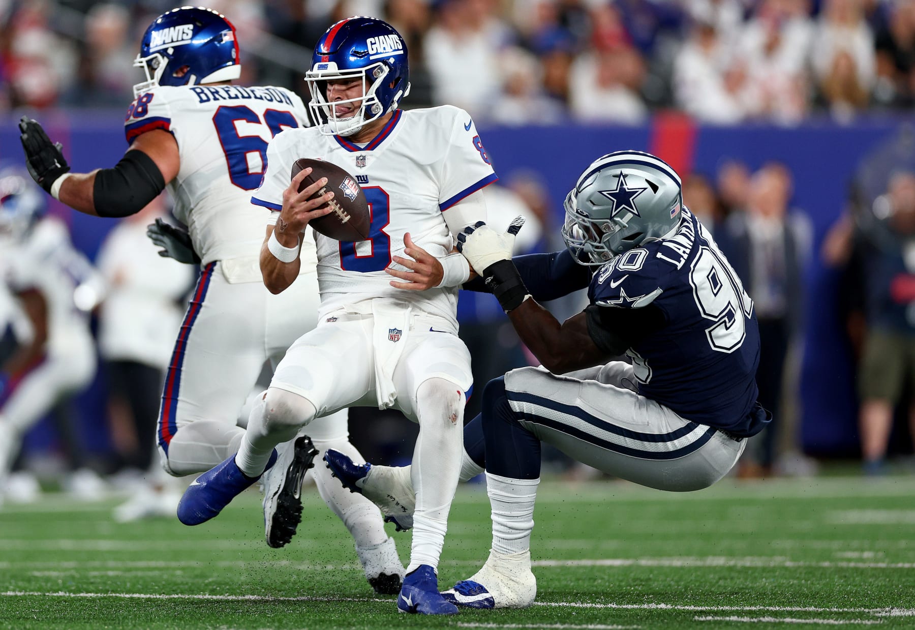 EAST RUTHERFORD, NEW JERSEY - SEPTEMBER 26: DeMarcus Lawrence #90 of the Dallas Cowboys sacks Daniel Jones #8 of the New York Giants during the second quarter in the game at MetLife Stadium on September 26, 2022 in East Rutherford, New Jersey. (Photo by Elsa/Getty Images)