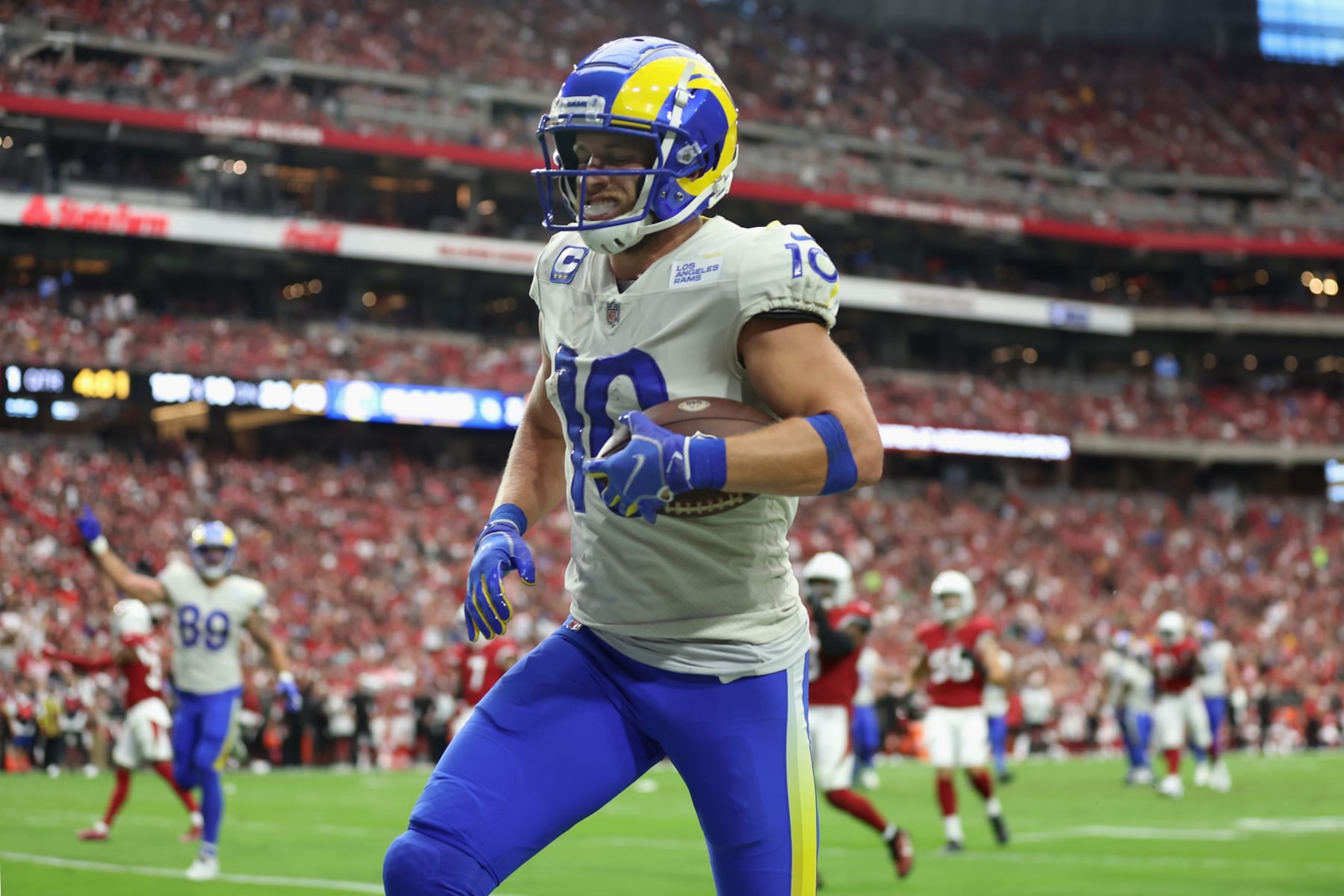 GLENDALE, ARIZONA - SEPTEMBER 25: Wide receiver Cooper Kupp #10 of the Los Angeles Rams scores on a 20-yard rushing touchdown against the Arizona Cardinals during the first half of the NFL game at State Farm Stadium on September 25, 2022 in Glendale, Arizona. The Rams defeated the Cardinals 20-12. (Photo by Christian Petersen/Getty Images) GLENDALE, ARIZONA - SEPTEMBER 25: Wide receiver Cooper Kupp #10 of the Los Angeles Rams scores on a 20-yard rushing touchdown against the Arizona Cardinals during the first half of the NFL game at State Farm Stadium on September 25, 2022 in Glendale, Arizona. The Rams defeated the Cardinals 20-12. (Photo by Christian Petersen/Getty Images)