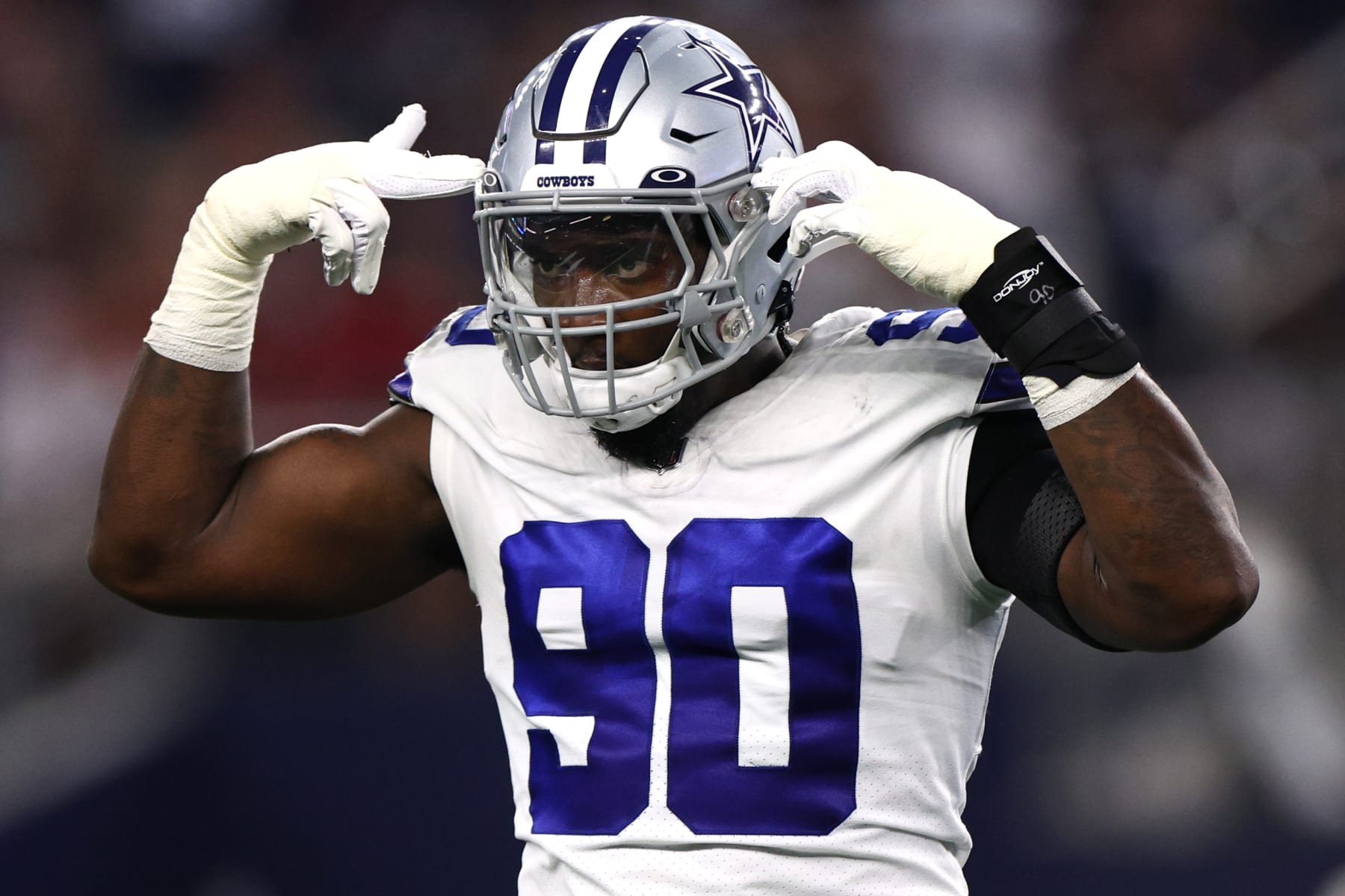 ARLINGTON, TEXAS - SEPTEMBER 11: DeMarcus Lawrence #90 of the Dallas Cowboys celebrates stopping Leonard Fournette #7 of the Tampa Bay Buccaneers behind the line of scrimmage during the first quarter at AT&T Stadium on September 11, 2022 in Arlington, Texas. (Photo by Tom Pennington/Getty Images)